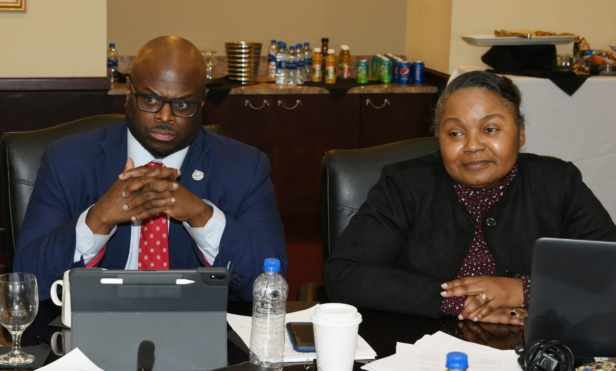 Dr. Tony Allen (seated in a meeting by Dr. DeLauder) said the new Provost has served Del State with distinction and grace.