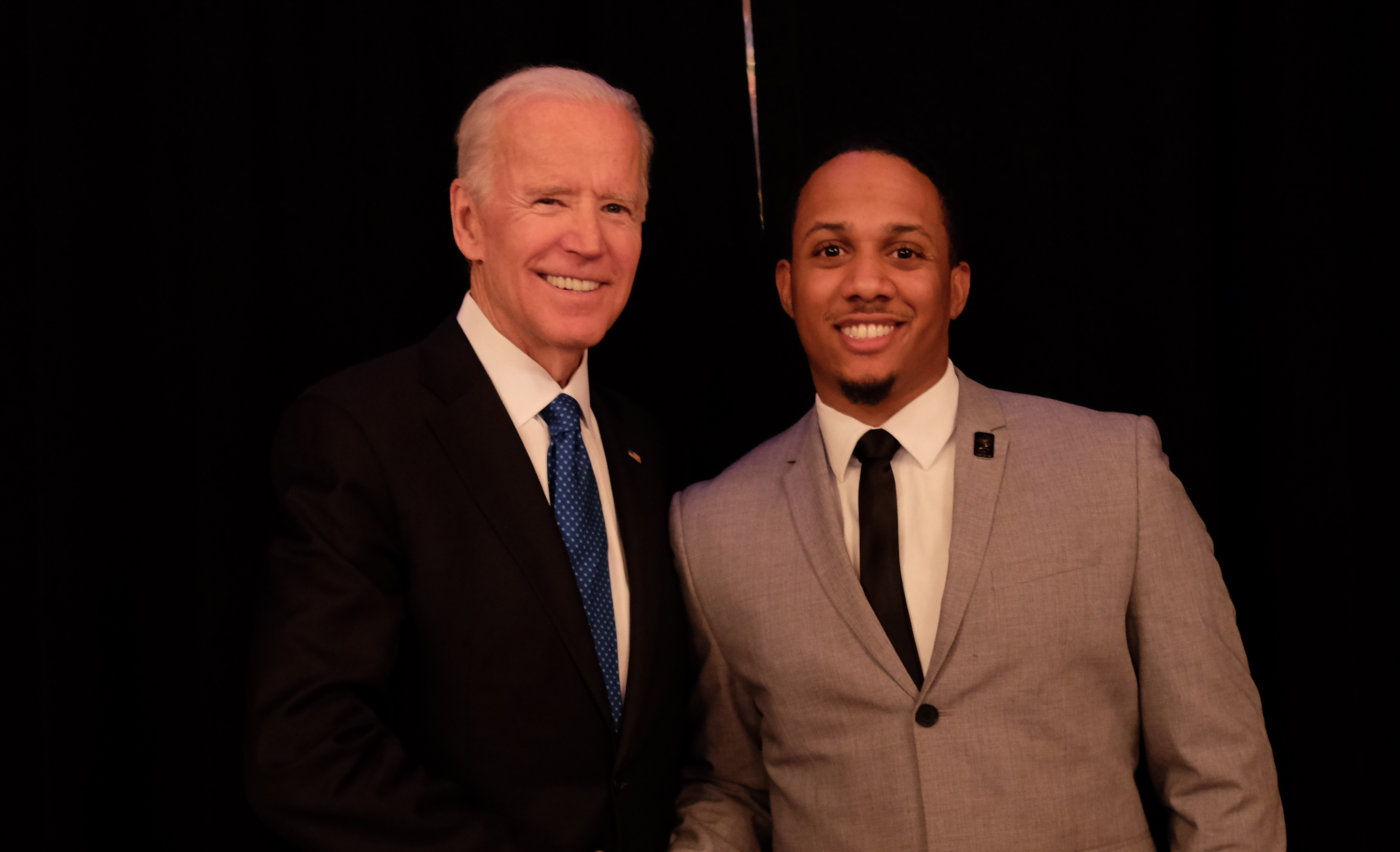 Former U.S. Vice President Joe Biden (l) congratulates Kyle Sheppard after presenting him the Biden Courage Award for his work at DSU to prevent sexual and domestic abuse.