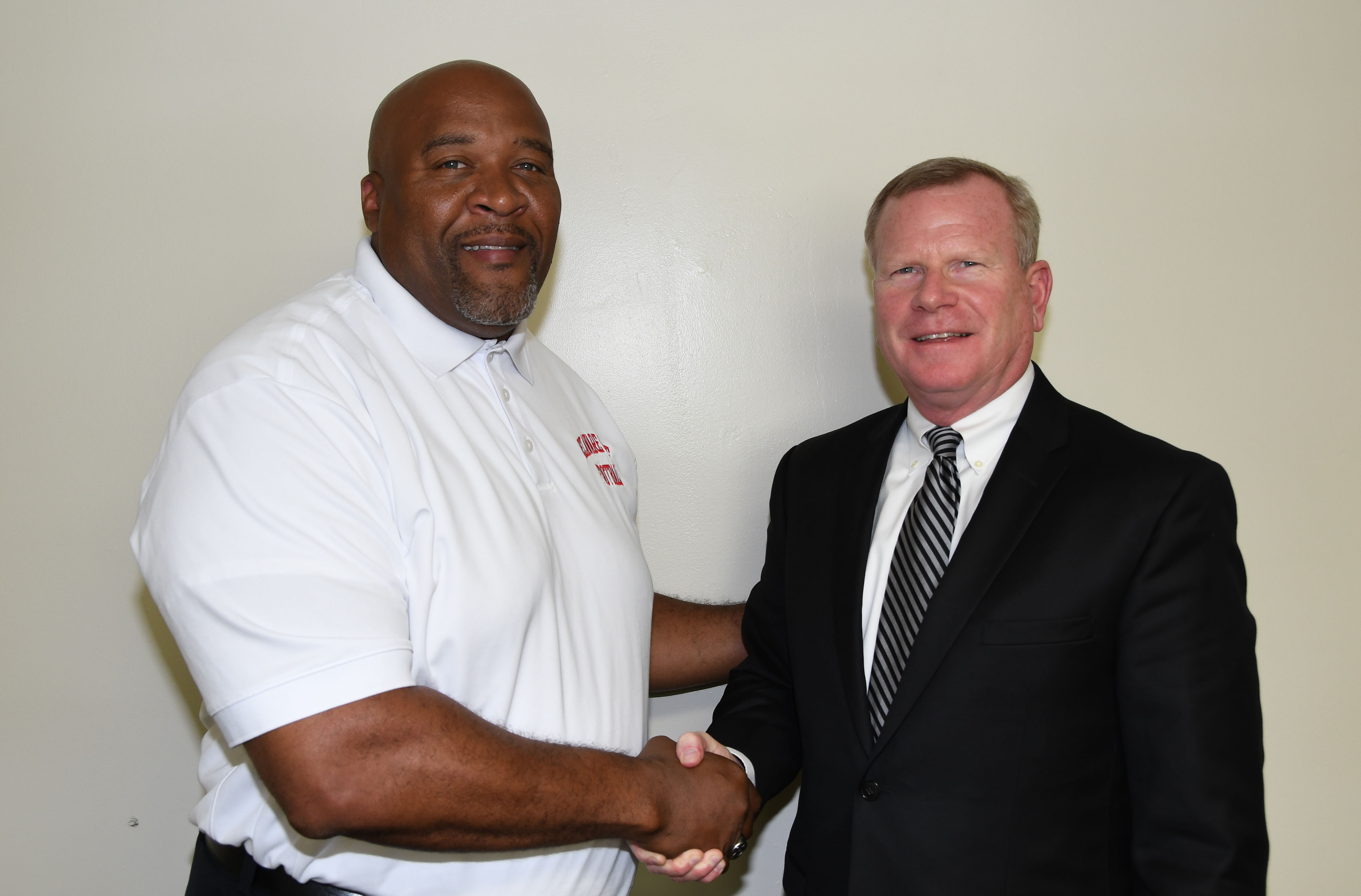 DSU Head Football Coach Rod Milstead welcomes his new boss (r) Dr. D. Scott Gines, who has been newly named the University's Athletic Director.
