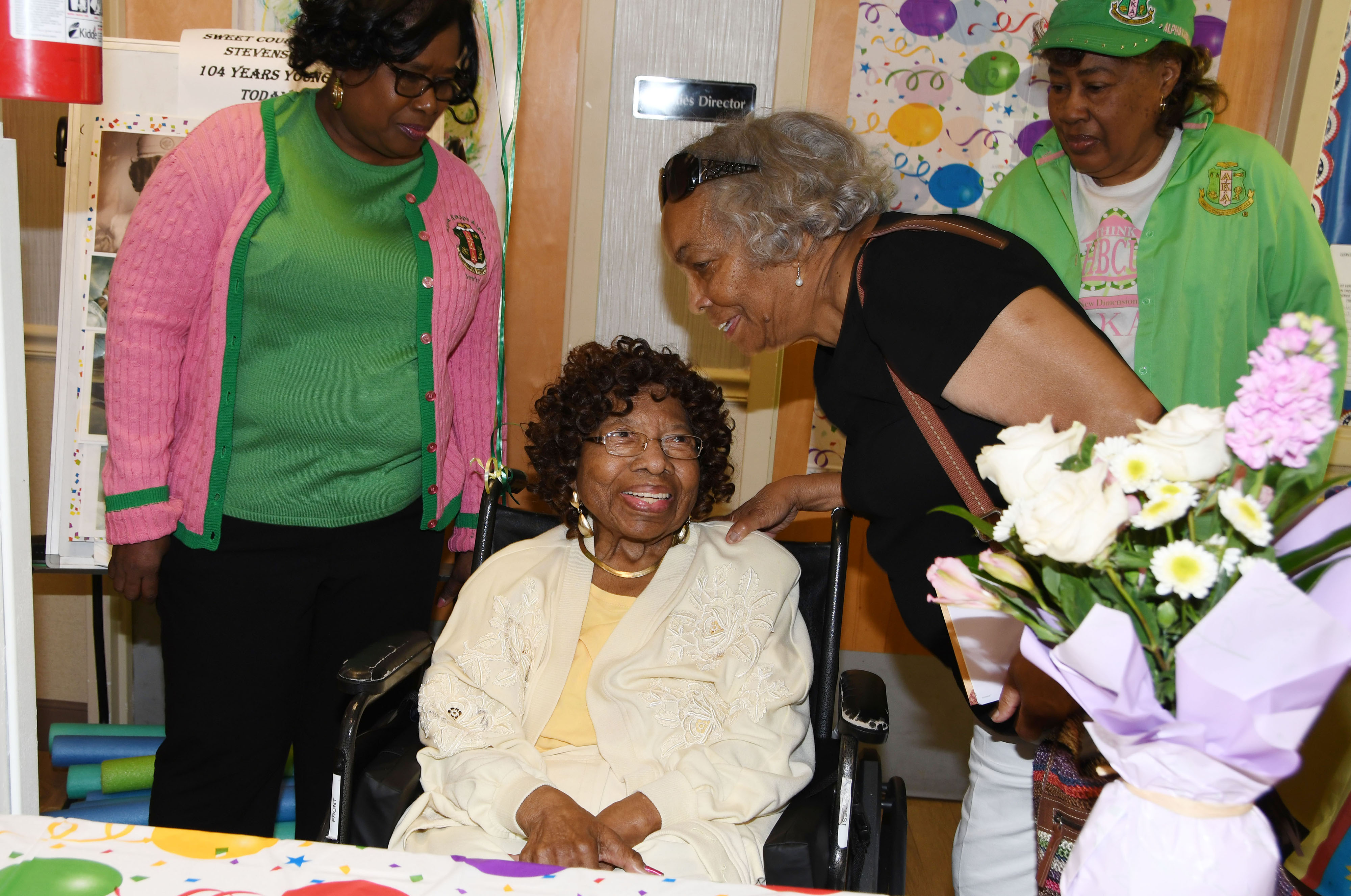 Courtney Stevenson (seated) talks with AKA sorority sister Peggy Swygert at her 104th birthday celebration at the Capital Rehabilitation Center where she lives.
