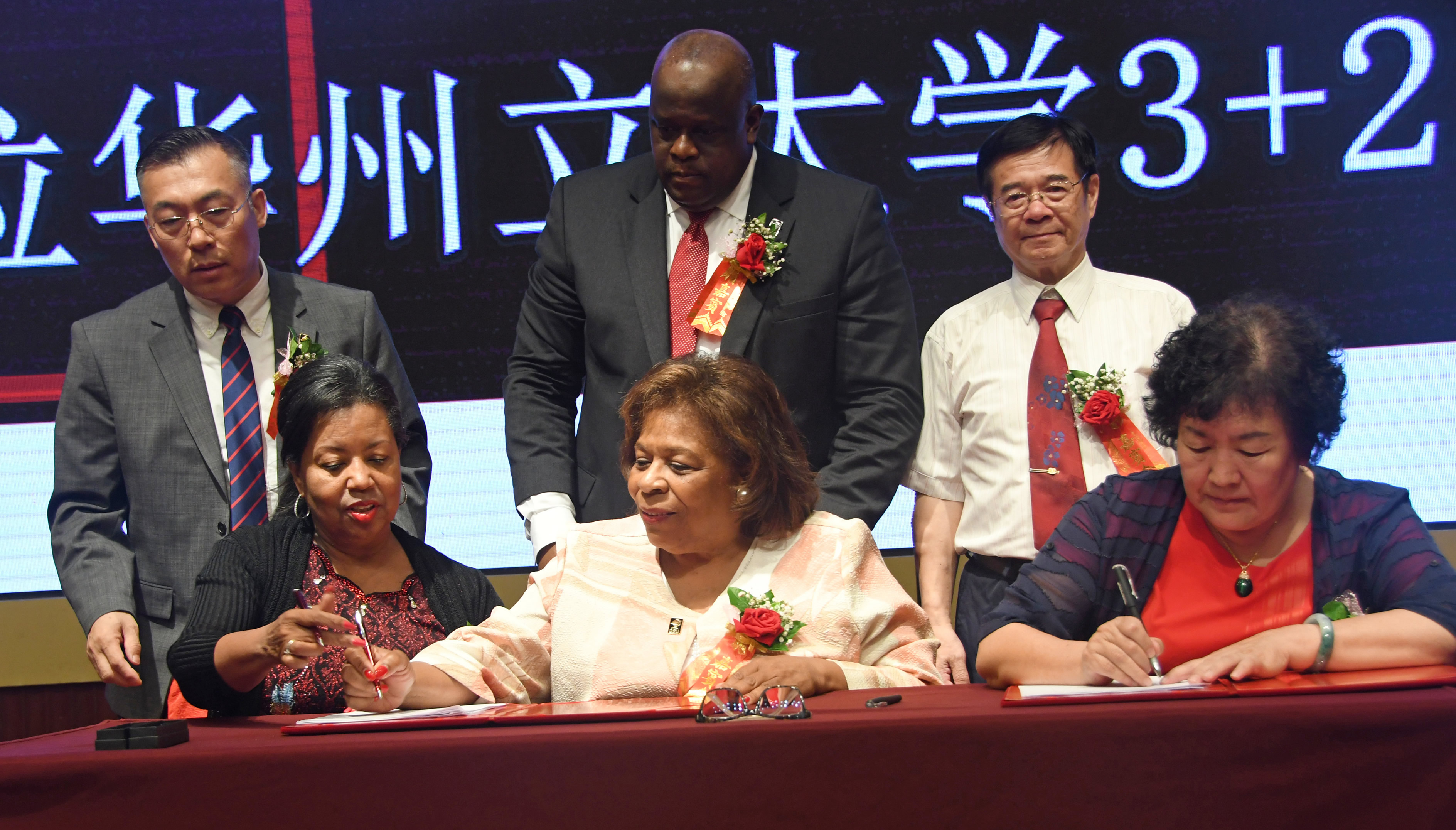 From left during the agreement signing are DSU Board of Trustees Chairwoman Devona Willliams, DSU President Wilma Mishoe and Li Mingzhen, president of Boya International Education, which the Jiaozuo Industry and Trade Vocational College is under.