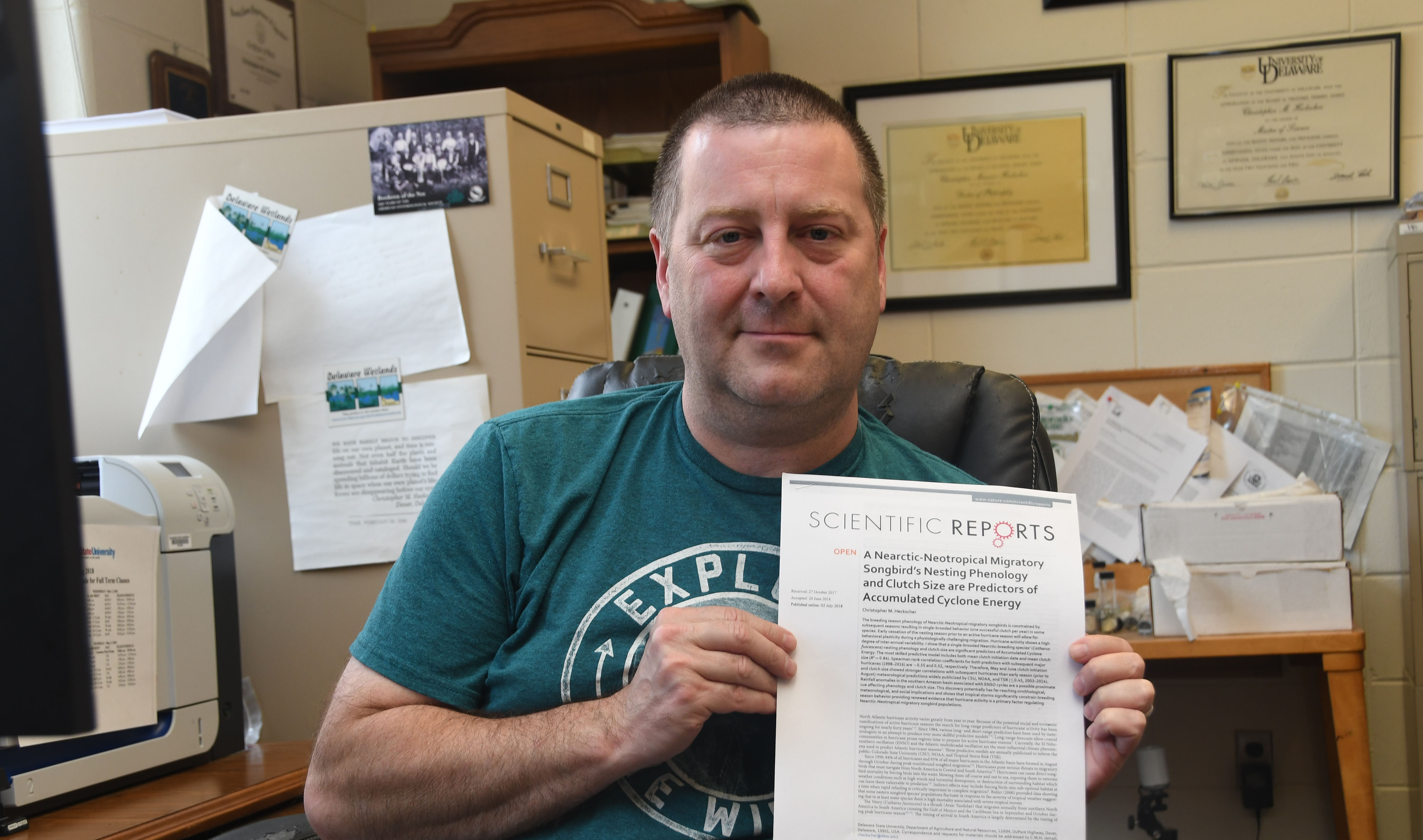 Dr. Christopher Heckscher shows the paper he has published on the relationship between Veery breeding length and hurricane season severity.