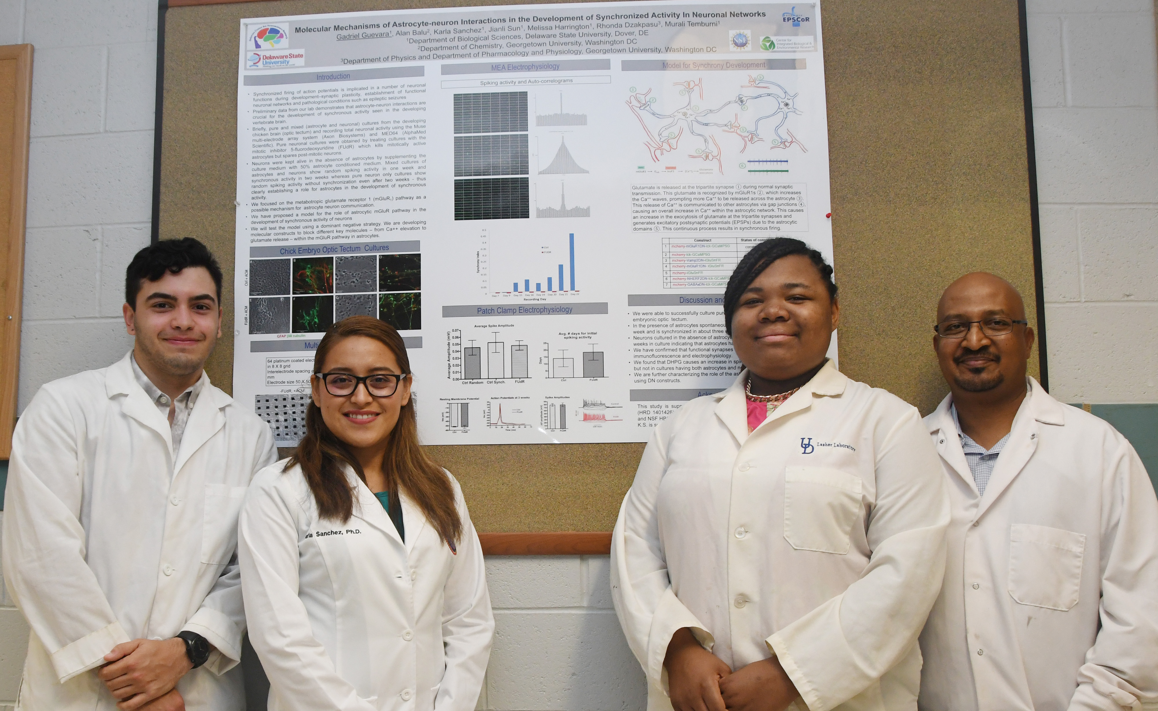 (L-r) Gadriel Guevara, Karla Sanchez, Destiny King and Dr. Murali Temburni stand in front of a poster that relates to their current neuroscience research being funded by the National Science Foundation.