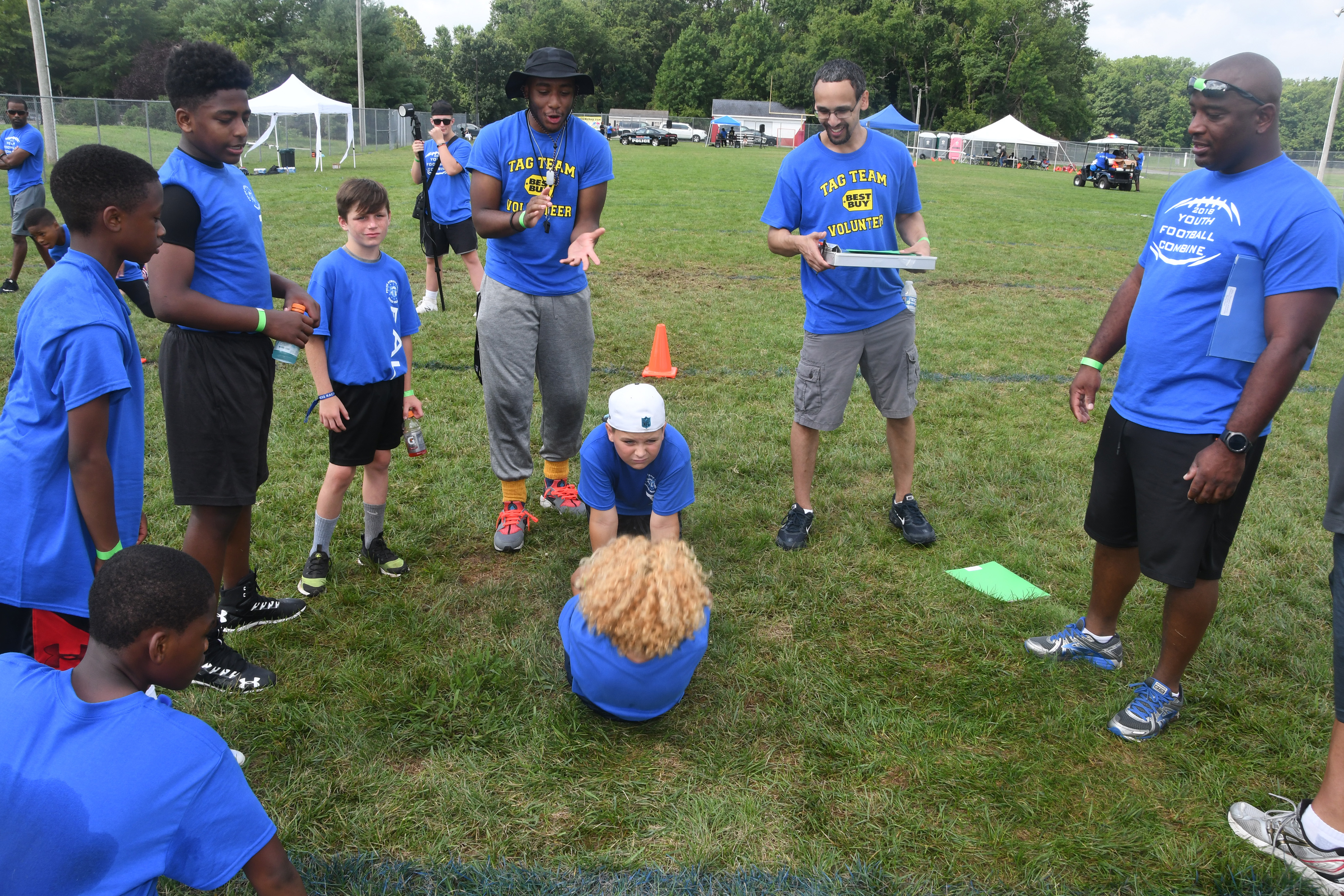 DSP-DSU volunteers and participants urge on a youth in his sit-up exercise efforts.
