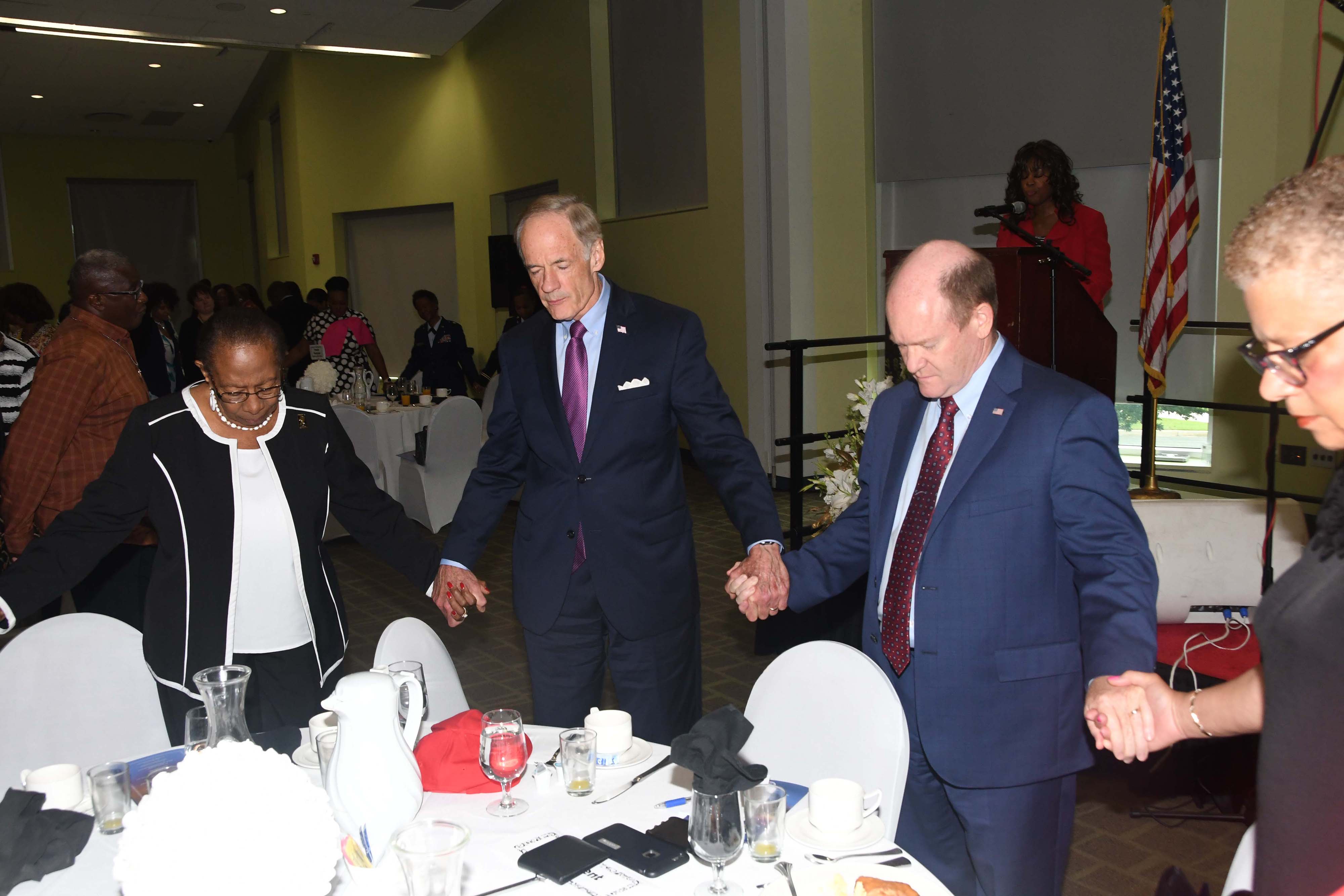 DSU alumna Dr. Reba Hollingsworth, U.S. Sen.Tom Carper and U.S. Sent Chris Coons join hand for the benediction prayer at the end of the 2018 President's Prayer Breakfast.