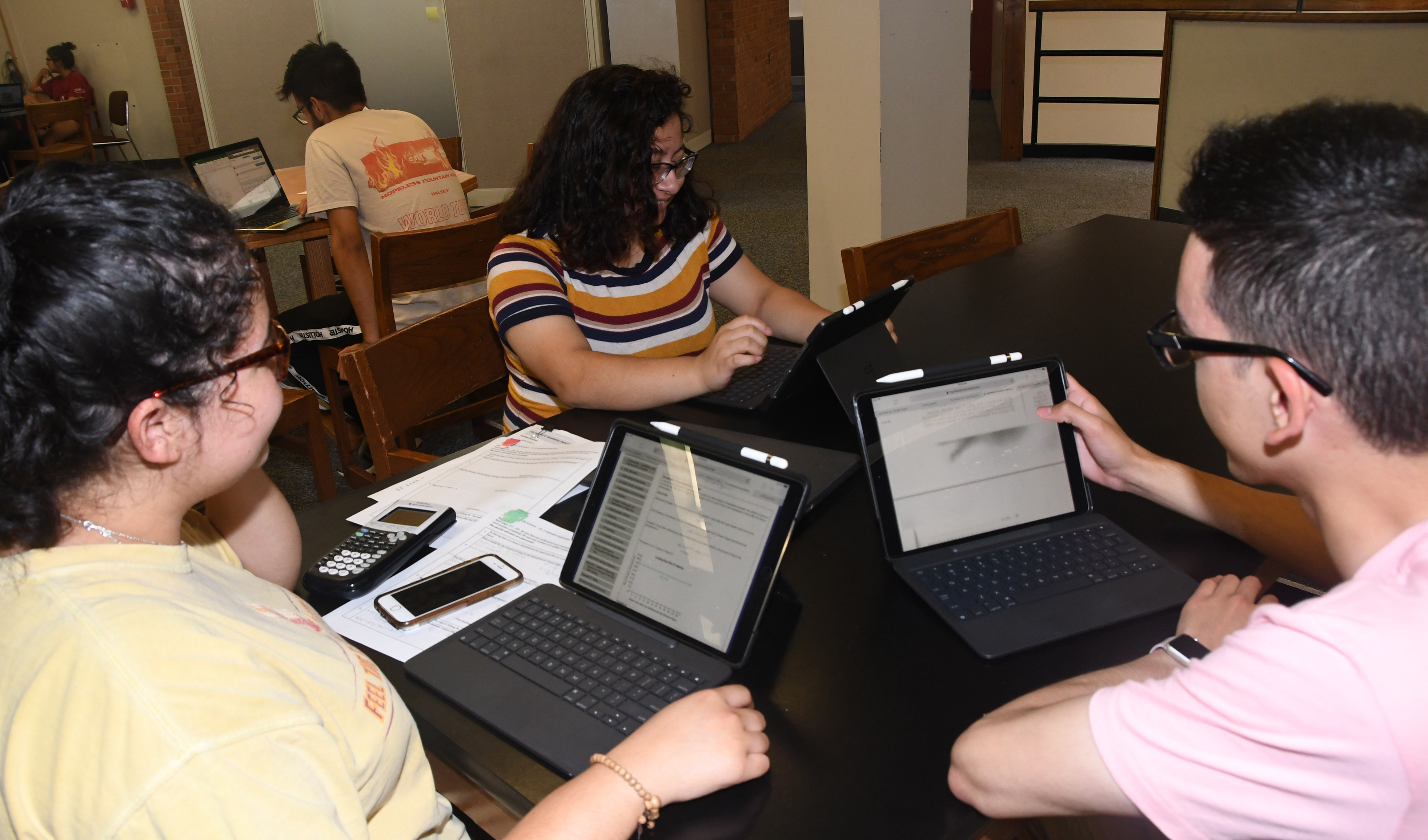 (lL-r) Freshmen students Karine Hernandez, Estefany Bonilla and Filiberto Camarillo have easily incorporated their new Apple iPad Pros into their study sessions.