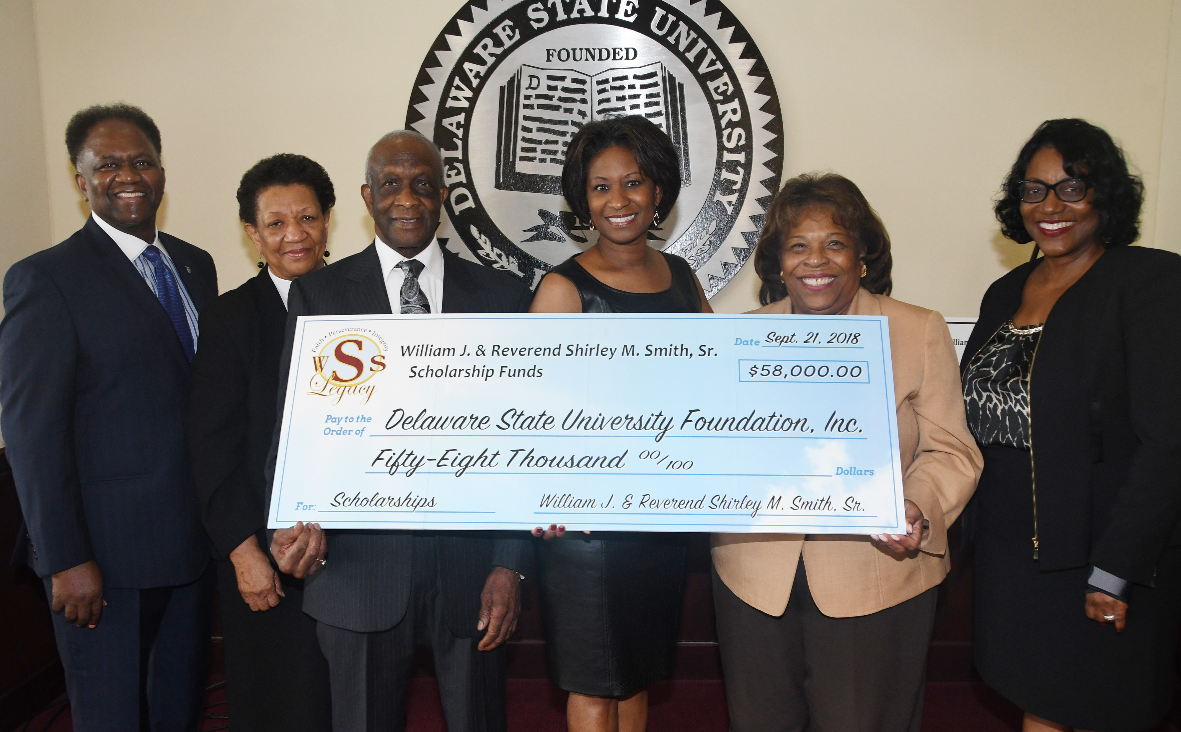 (L-r) H.L. Larry, Rev. Shirley Smith, William J. Smith, S. Renee Smith-Larry, University President Wilma Mishoe, and Dr. Vita Pickrum pose for a photo after the Smiths presented the check to the institution.
