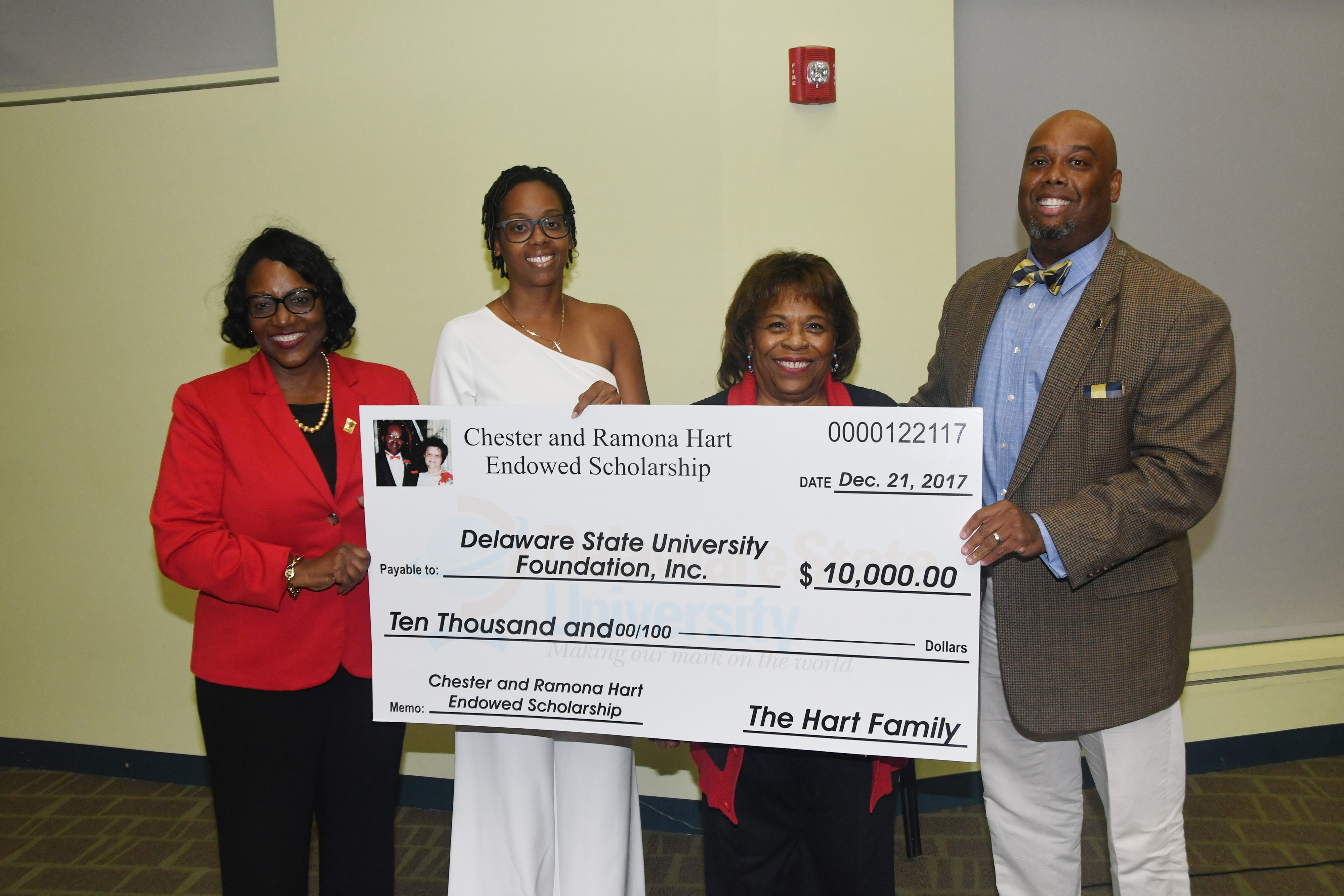Holding a display check for the newly established Chester and Ramona Hart Endowed Scholarship are (l-r) Dr. Vita Pickrum, Vice President of Institutional Advancement, Dana Hart-Raynor, University President Wilma Mishoe and Eric Hart.