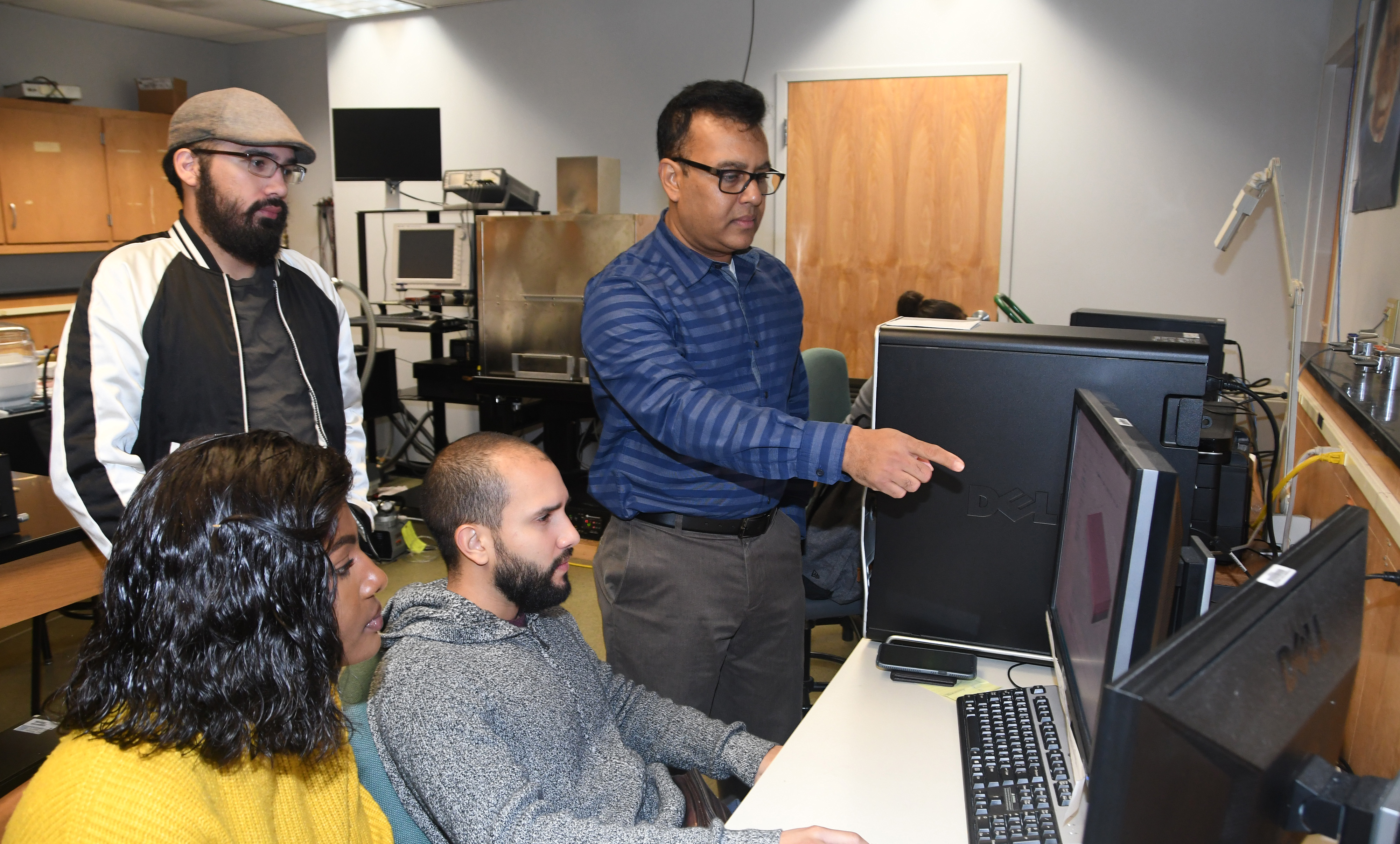 Dr. Mukti Rana (r), principal investigator of the grant, will provide these students -- (l-r) Larine Mbabit, Jaime Cardona and Kevin Diaz -- and others some hands-on research experience through this project.