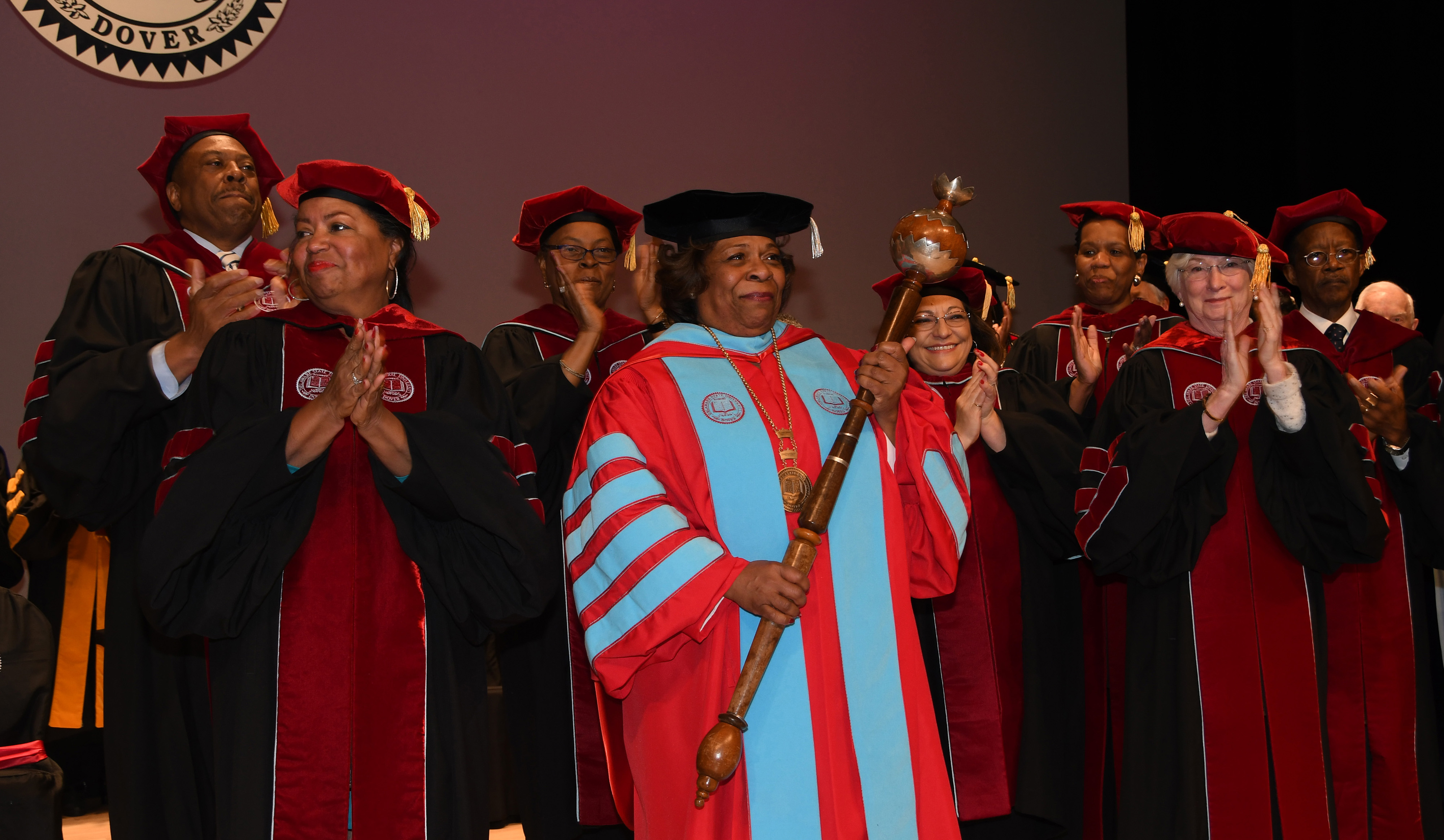 Surrounded by the University's Board of Trustees, the institution's 11th President receives the applause of all those in attendance at the Investiture Ceremony in the Education & Humanities Theatre.