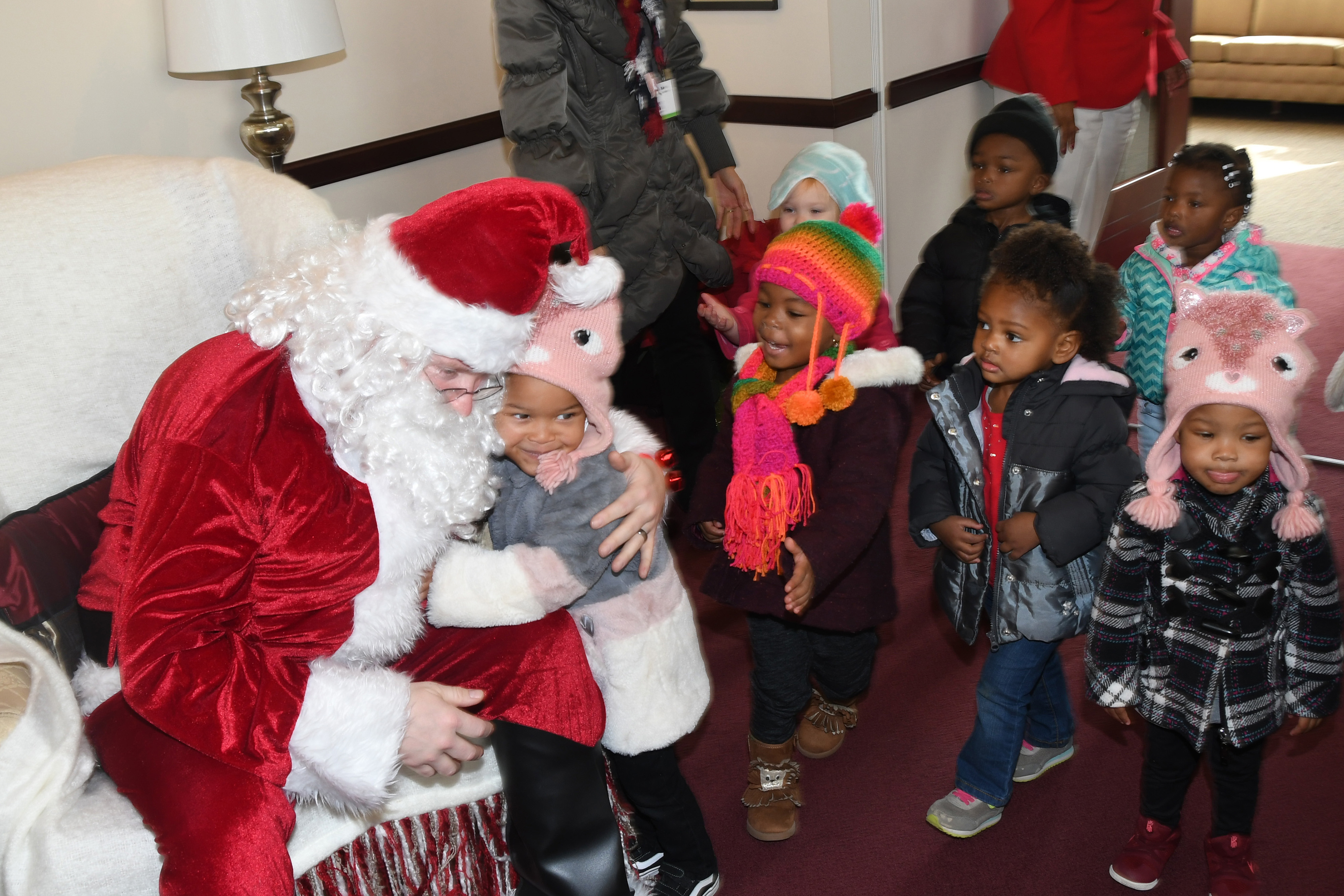 Santa Claus (portrayed by guess who?) greets the young ones of the Child Development Lab in the President's Office on Dec. 13.