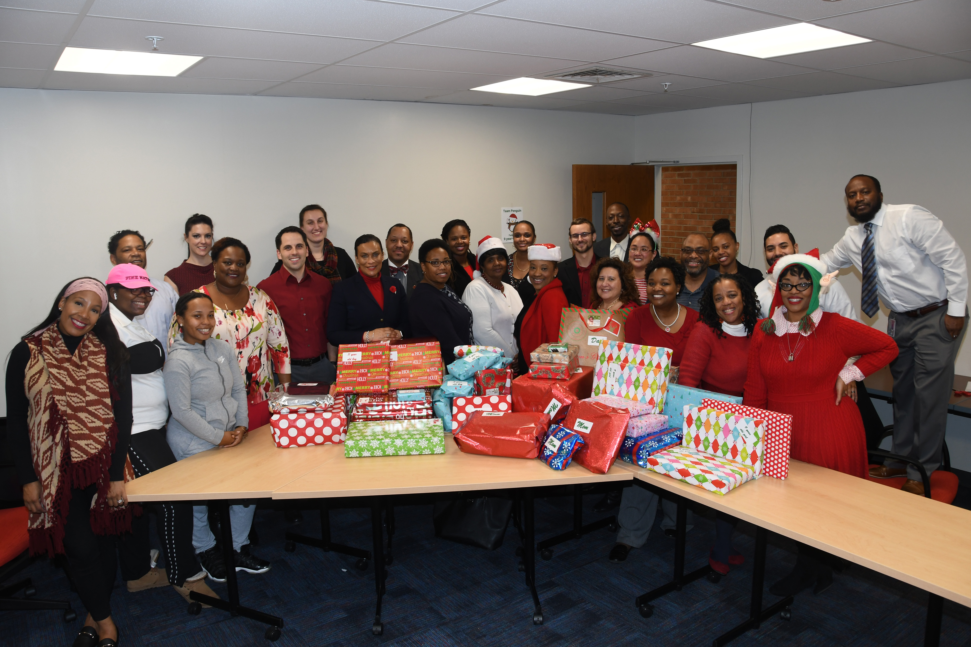 The Office of Student Success staff shows the fruits of their benevolence -- Christmas gifts for two disadvantaged families it has adopted for this holiday season.