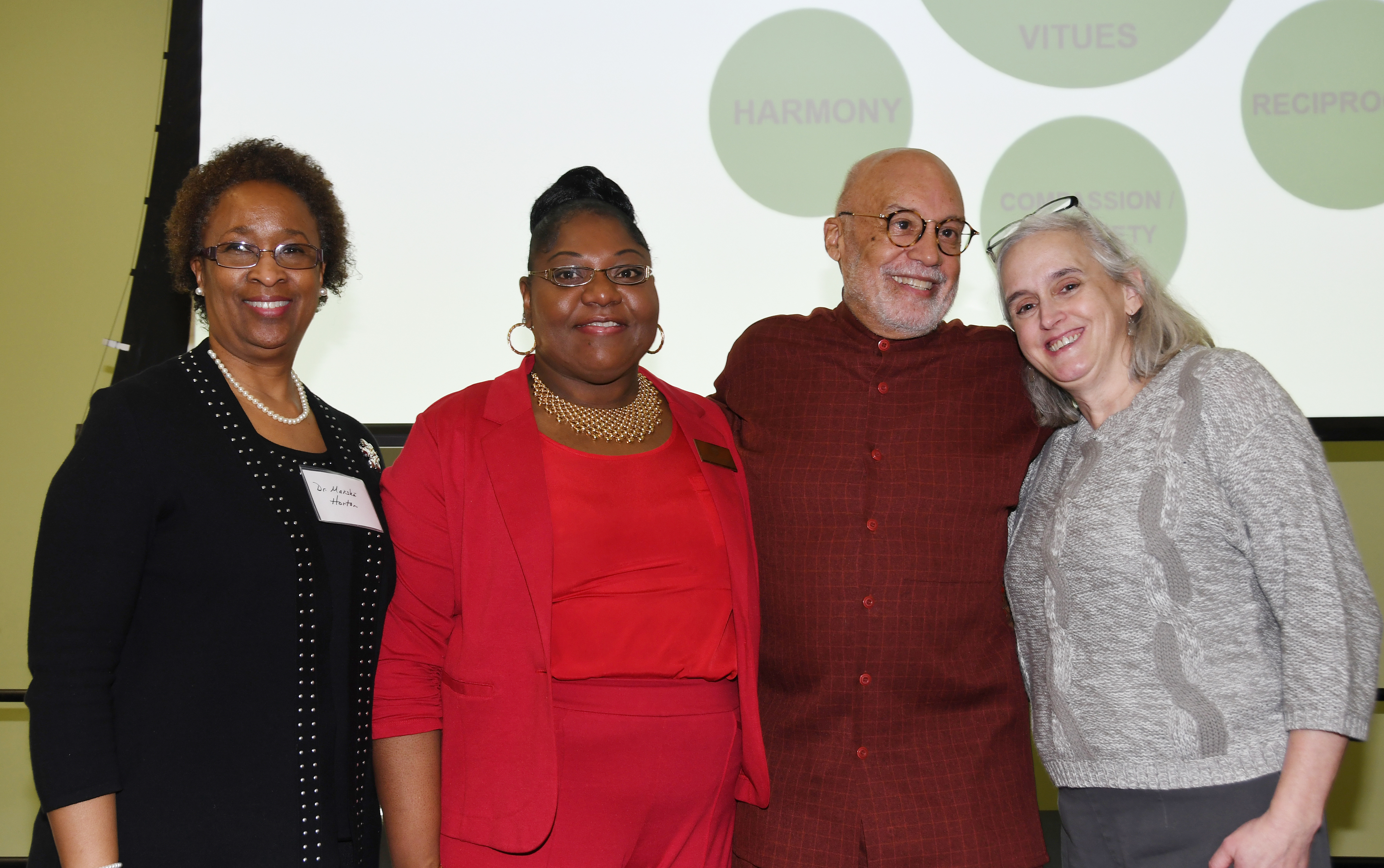 (L-r) Dr. Marsha Horton, dean of the College of Health & Behavioral Sciences, Dr. Gwen Scott-Jones, chair of the Dept. of Psychology, keynote speaker Aminifu R. Harvey, and Del. First Lady Tracey Carney, pose during a Feb. 14 conference entitled "Shifting from Trauma Informed Care to an African Healing Centered Approach."