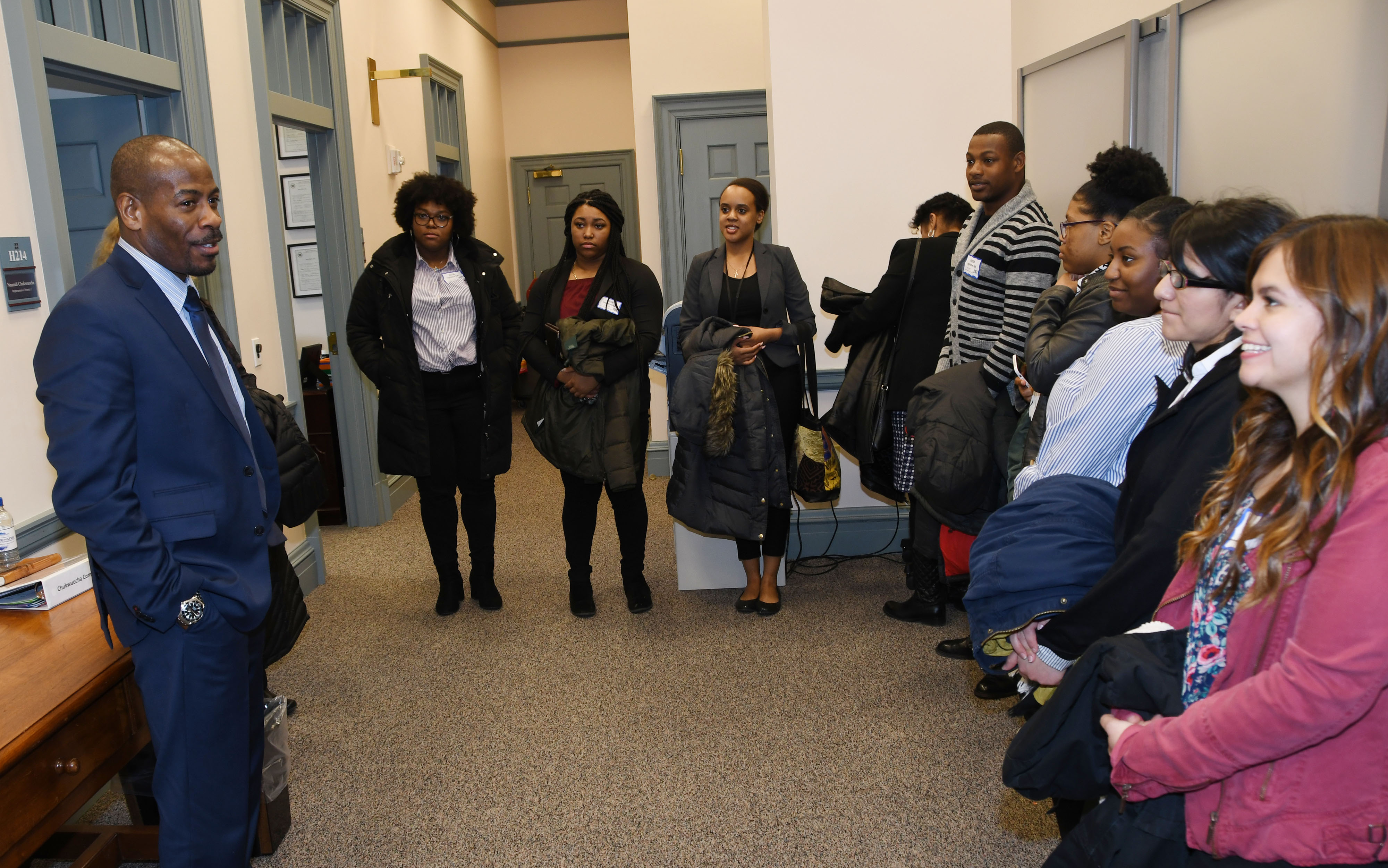 Rep. Nnamdi Chukwuocha, a University alumnus, speaks to a group of DSU social work students outside of his office at Legislative Hall.