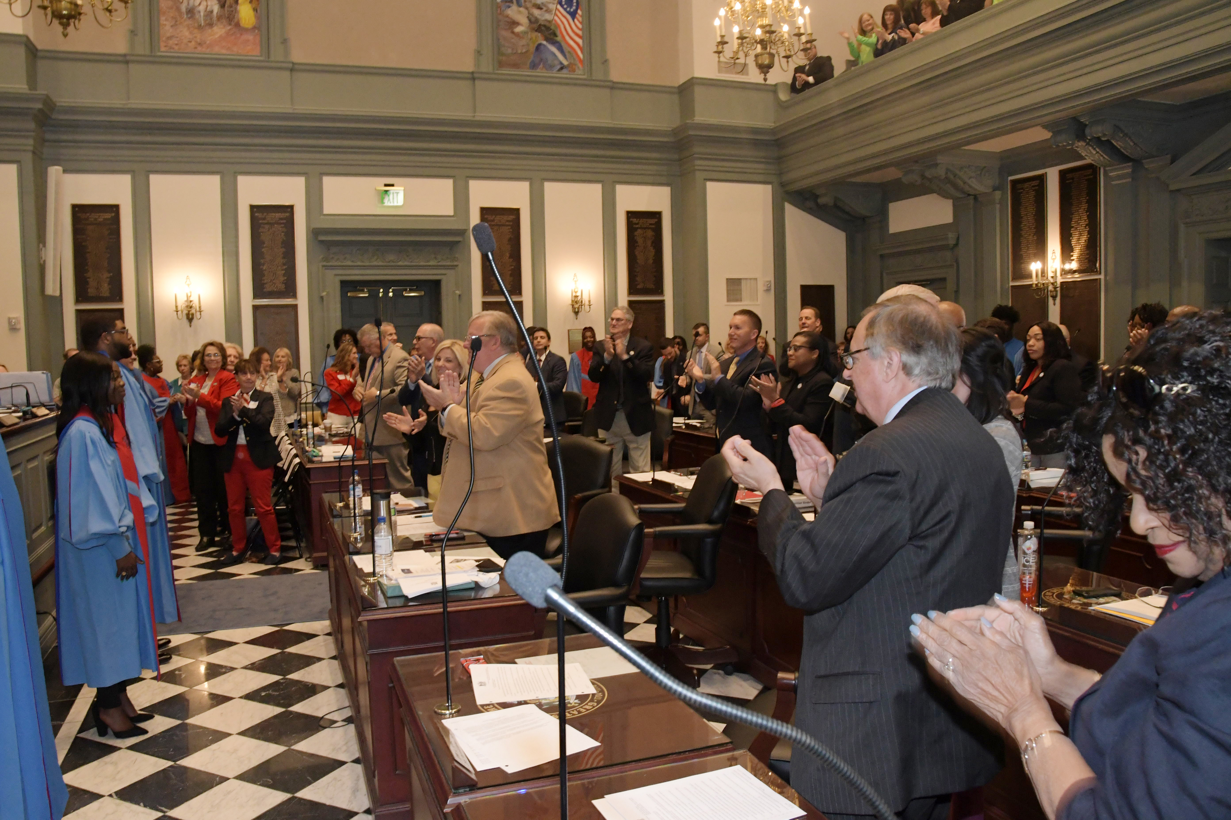 The University's Concert Choir receives a standing ovation from the House of Representatives following an April 17 performance.