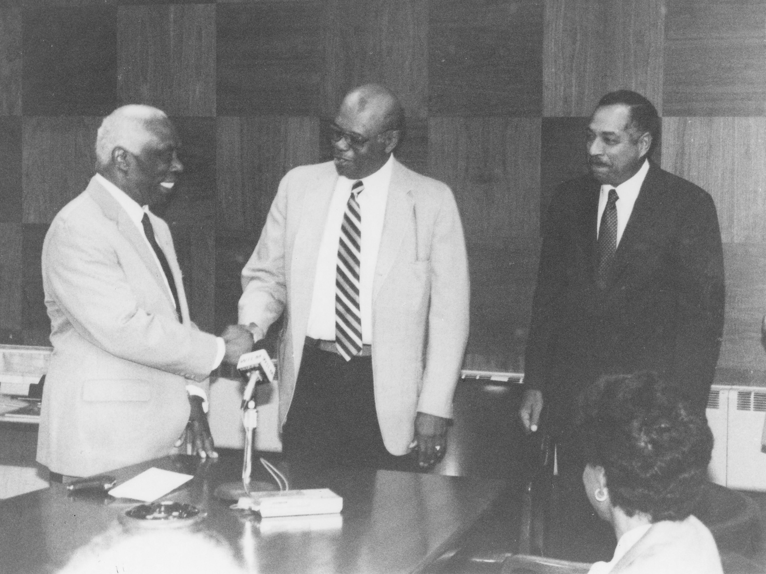 The historic 1987 passing of the presidential torch between then-outgoing DSC President Luna I. Mishoe (l) and his successor Dr. William B. DeLauder (r). Then-Board of Trustees President William Dix (center) shakes Dr. Mishoe's hand.