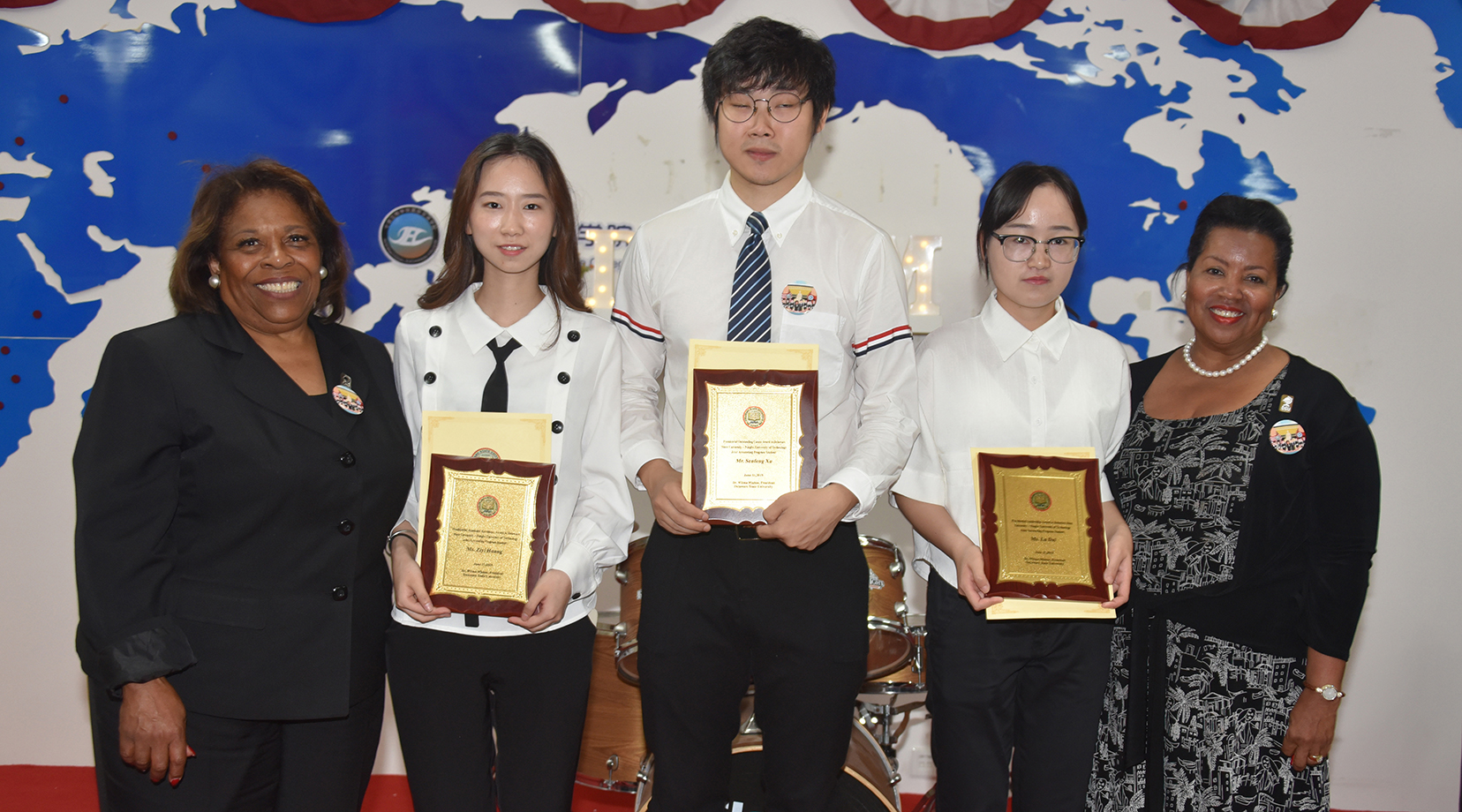 Three students – Ziyi Zhang, Senfeng Xu and Lu Dai – were presented with Delaware State University’s Presidential Academic Excellence Award. They are pictured with Dr. Wilma Mishoe and Dr. Devona Williams.