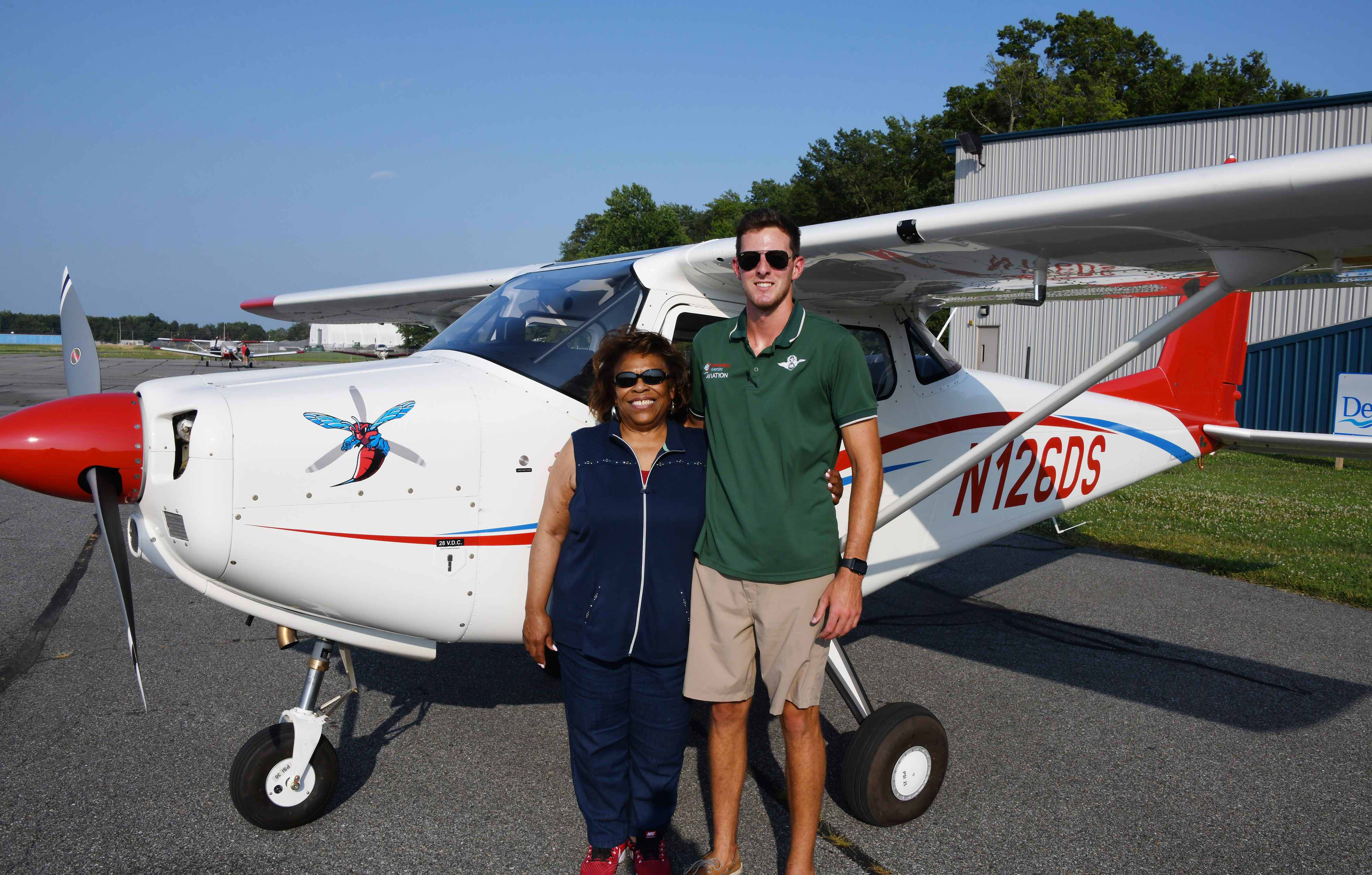 DSU President Wilma Mishoe poses with Aviation Program graduate and current Instructor B. Lane DeLeon after flying into the Delaware Air Park on the first aircraft of a new fleet planes for the University. 