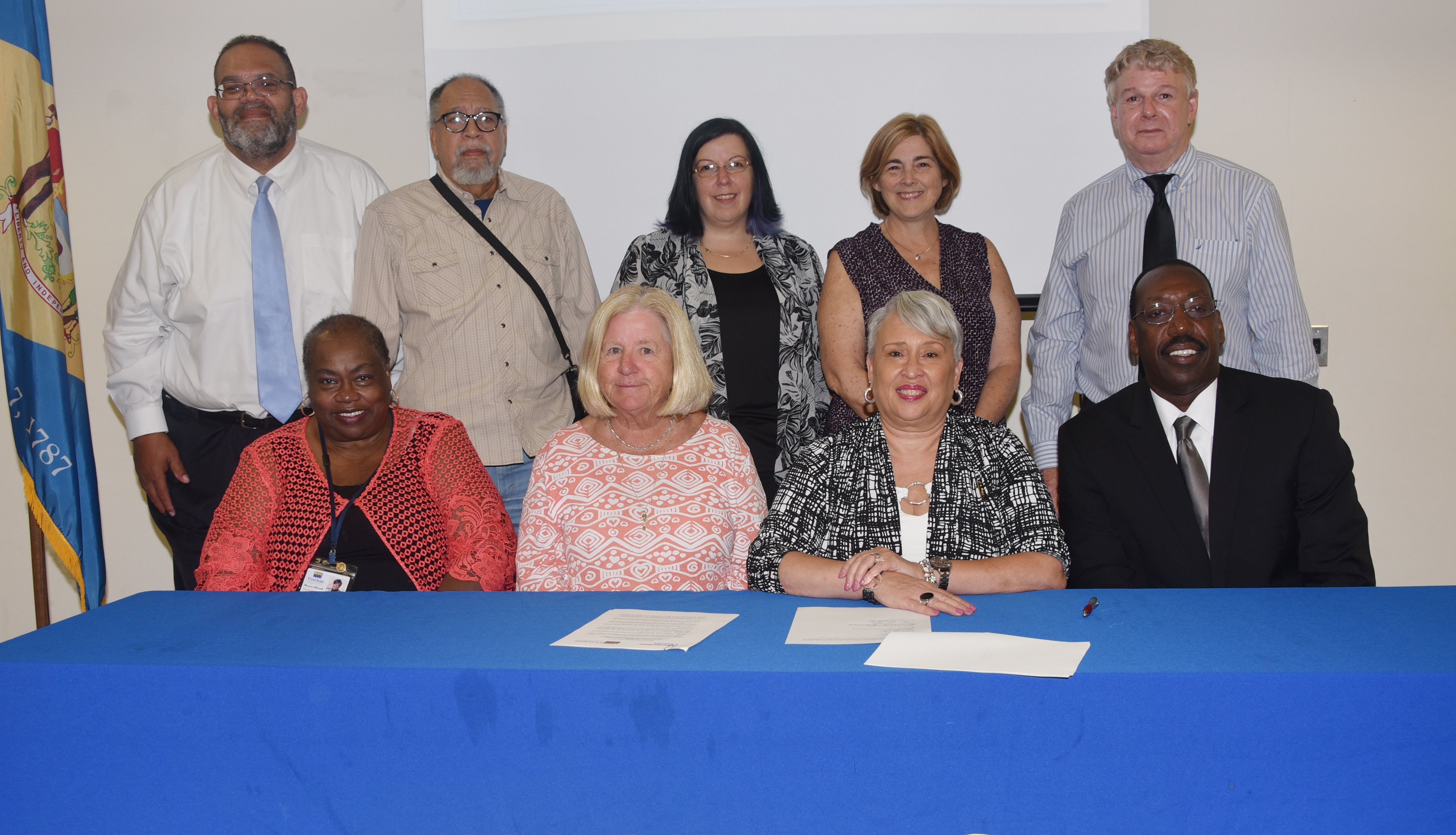 (Seated l-r) FSCAA's Bernice Edwards, exec. director, and Dr. Anne Farley, board president; DSU's Dr. Patrice Gilliam-Johnson, dean of Graduate, Adult and Extended Studies, and Dr. Darren Blackston, DSU@Georgetown director. (Standing) FSCAA officials Bruce Wright, Cagney J. France and Jaime Sayler; DSU's Lisa Perelli; and Brad Whaley of the Sussex County Office of Community Development pose after the signing.
