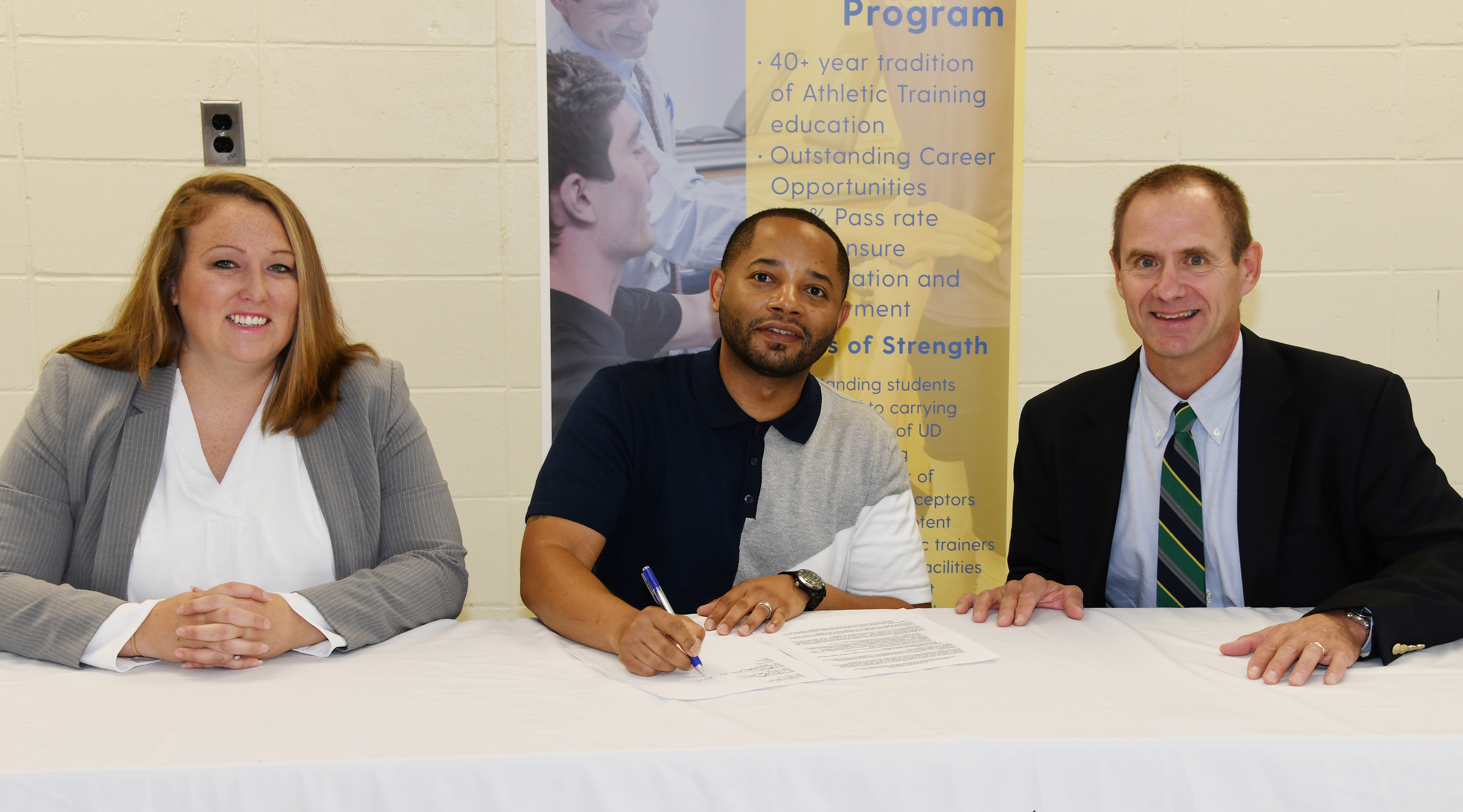 Delaware State University's Dr. Cara Gomez and Dr. R. Christopher Mason join UD's Dr. Thomas Kaminski in signing an agreement that will create a pipeline for kinesiology students to enroll in UD's Athletic Training Master's Degree Program.