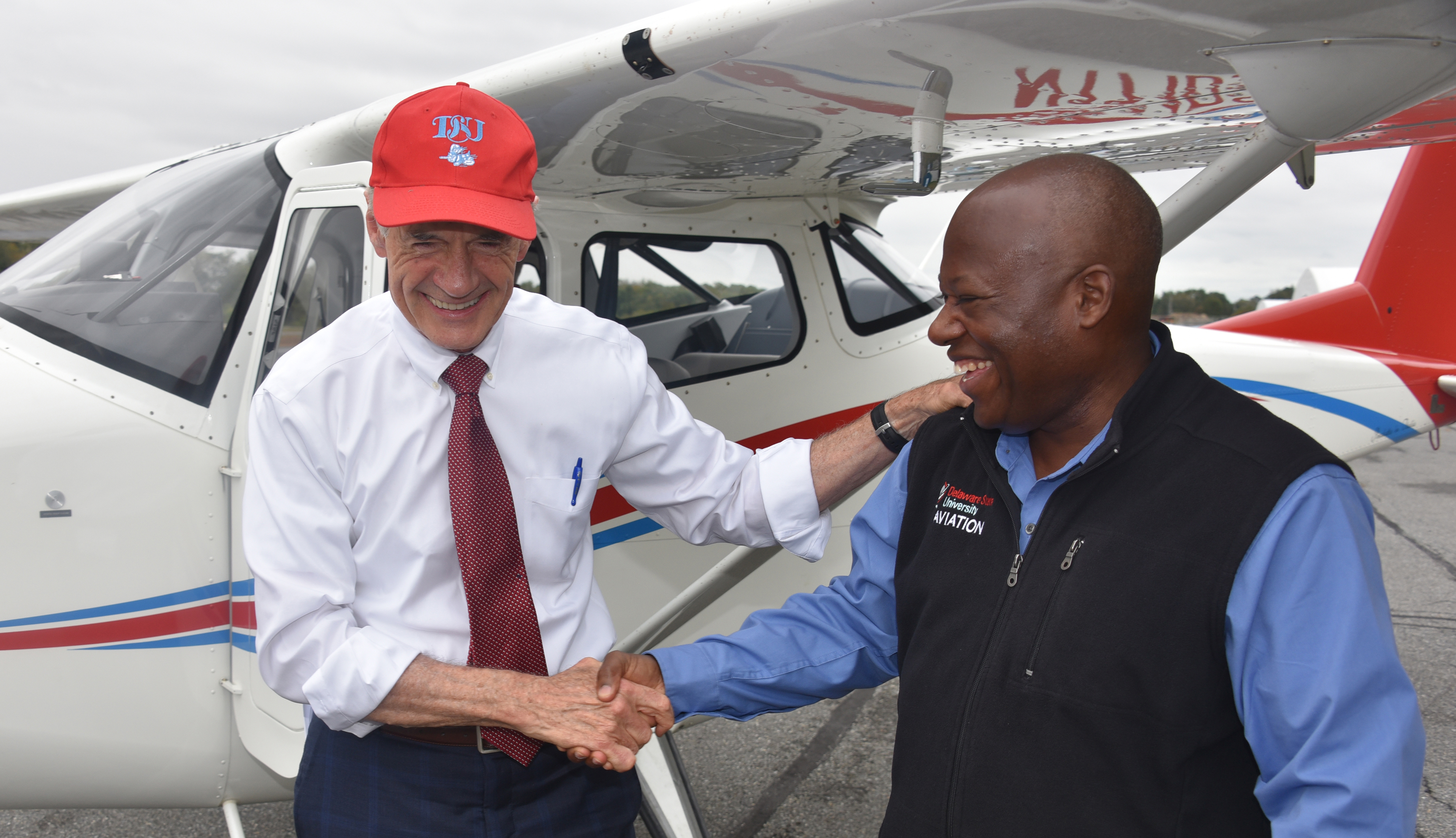 U.S. Sen. Tom Carper shakes hands with Lt. Col. Michael Hales, director of the University's Aviation Program, after the elected official flew one of the new planes recently acquired by Del State. Sen. Carper is a former naval aviator.