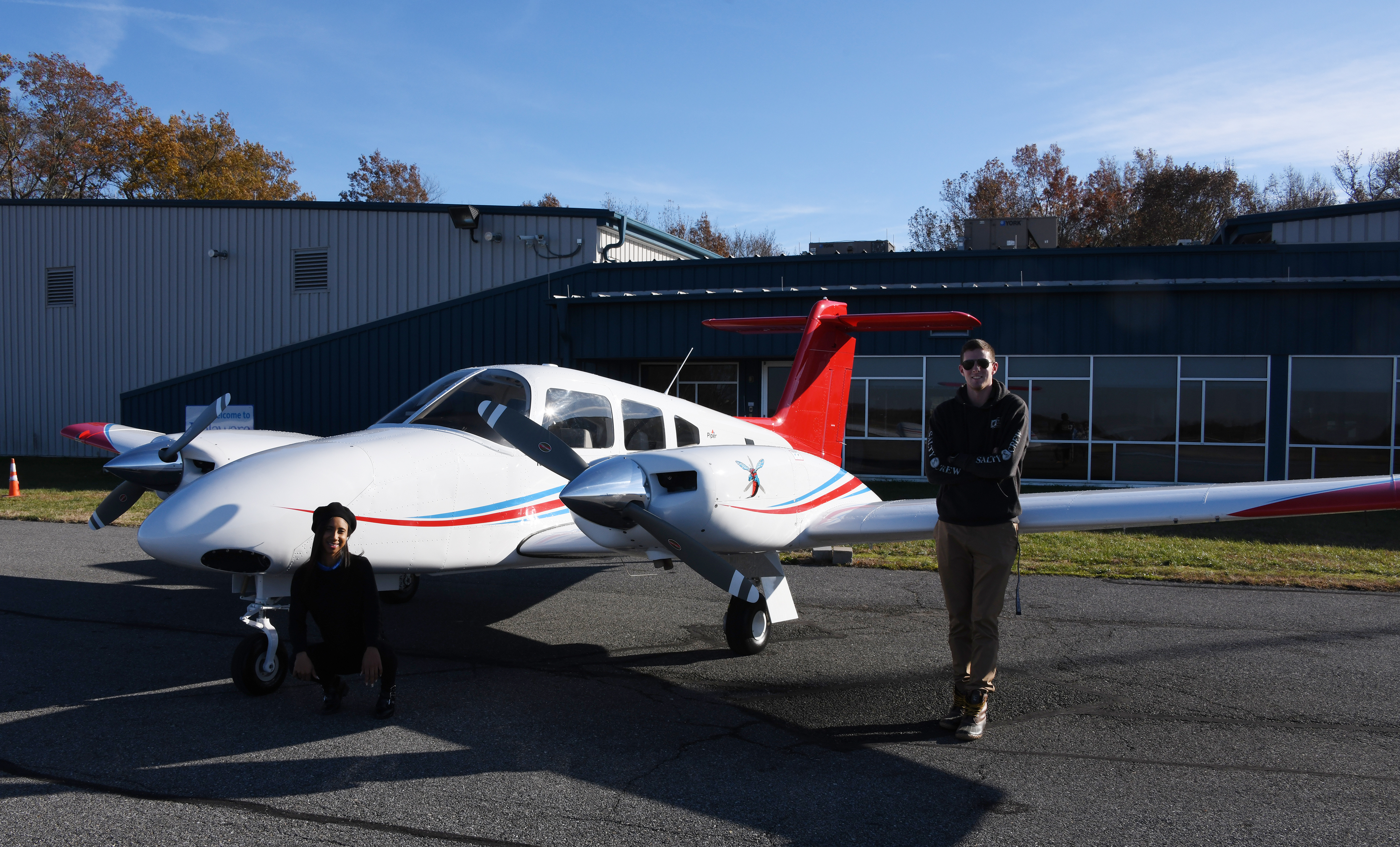 Zaneasia Perry, freshman aviation major, and Lane Deleon, flight instructor and Aviation Program alumnus, pose next to the new twin-engine Piper Seminole recently delivered to the Aviation Program at the Delaware Air Park.