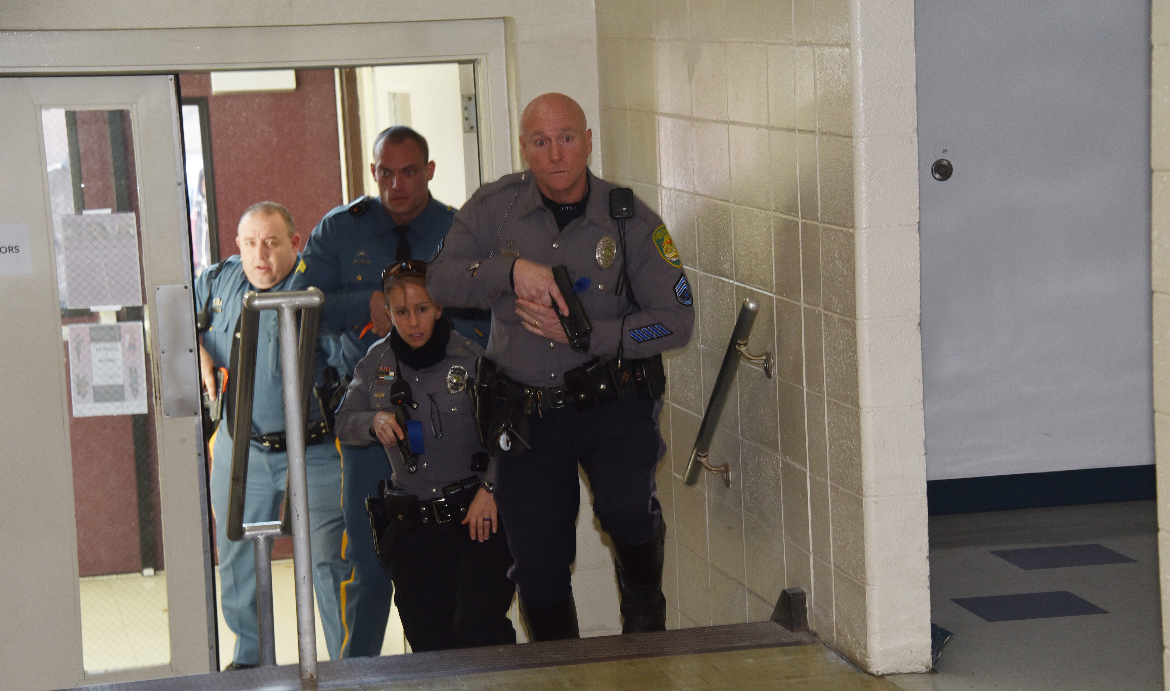 Law enforcement officers from the University Police and the Delaware State Police storm the Price Building during a Jan. 21 active shooter exercise.