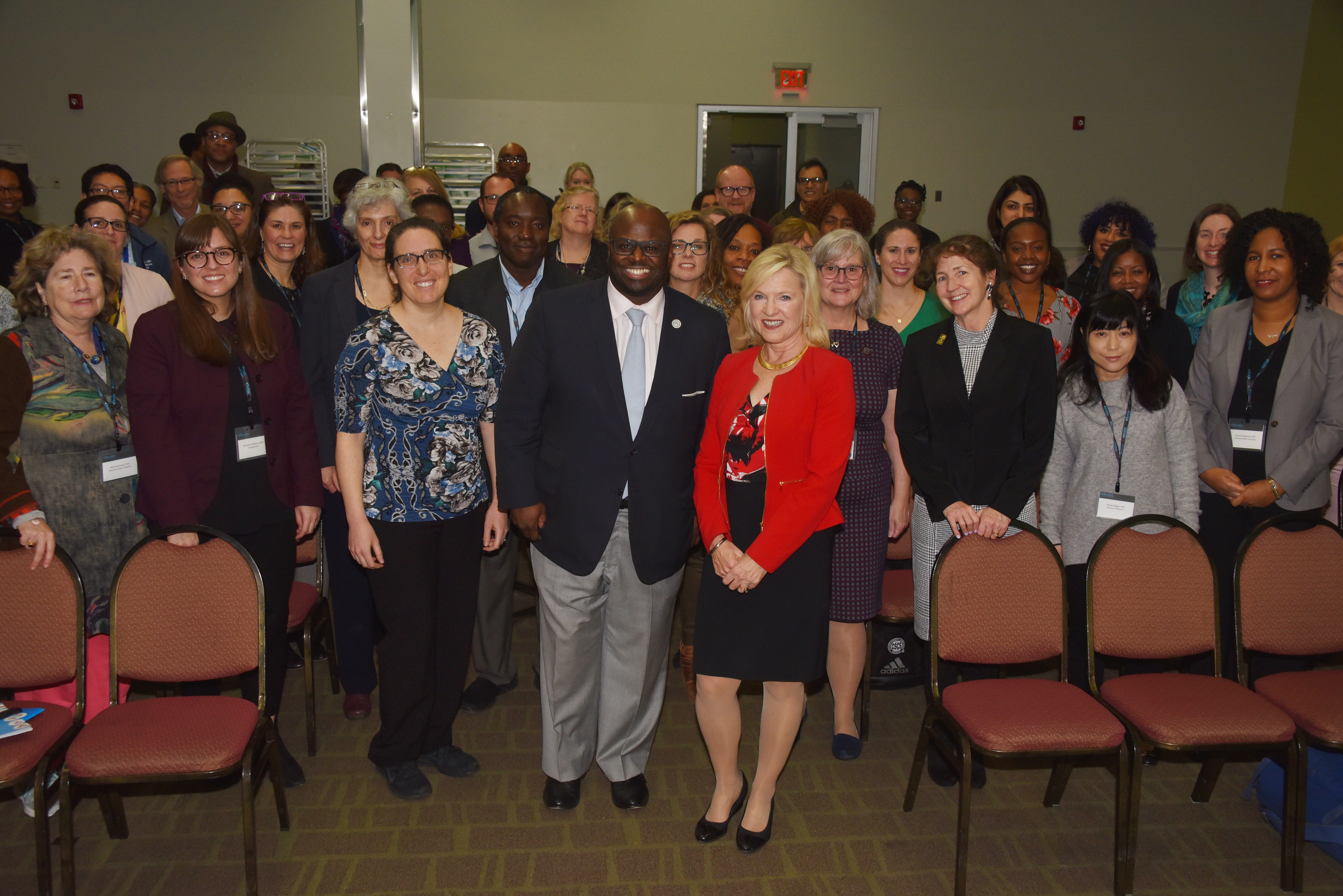 University President Tony Allen (center) and keynote speaker Del. Lt. Gov. Bethany Hall-Long join the other ACCEL Behavioral and Mental Health Retreat participants for a photo.