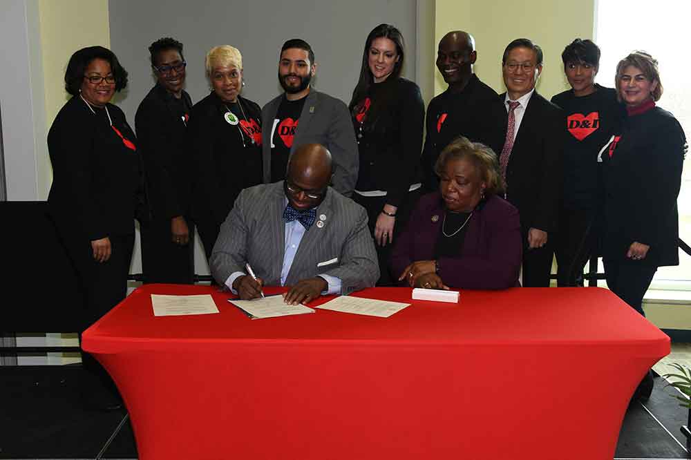 University President Tony Allen signs a Diversity and Inclusion Proclamation with the Task Force that studied the issue on campus witnessing his signature. 