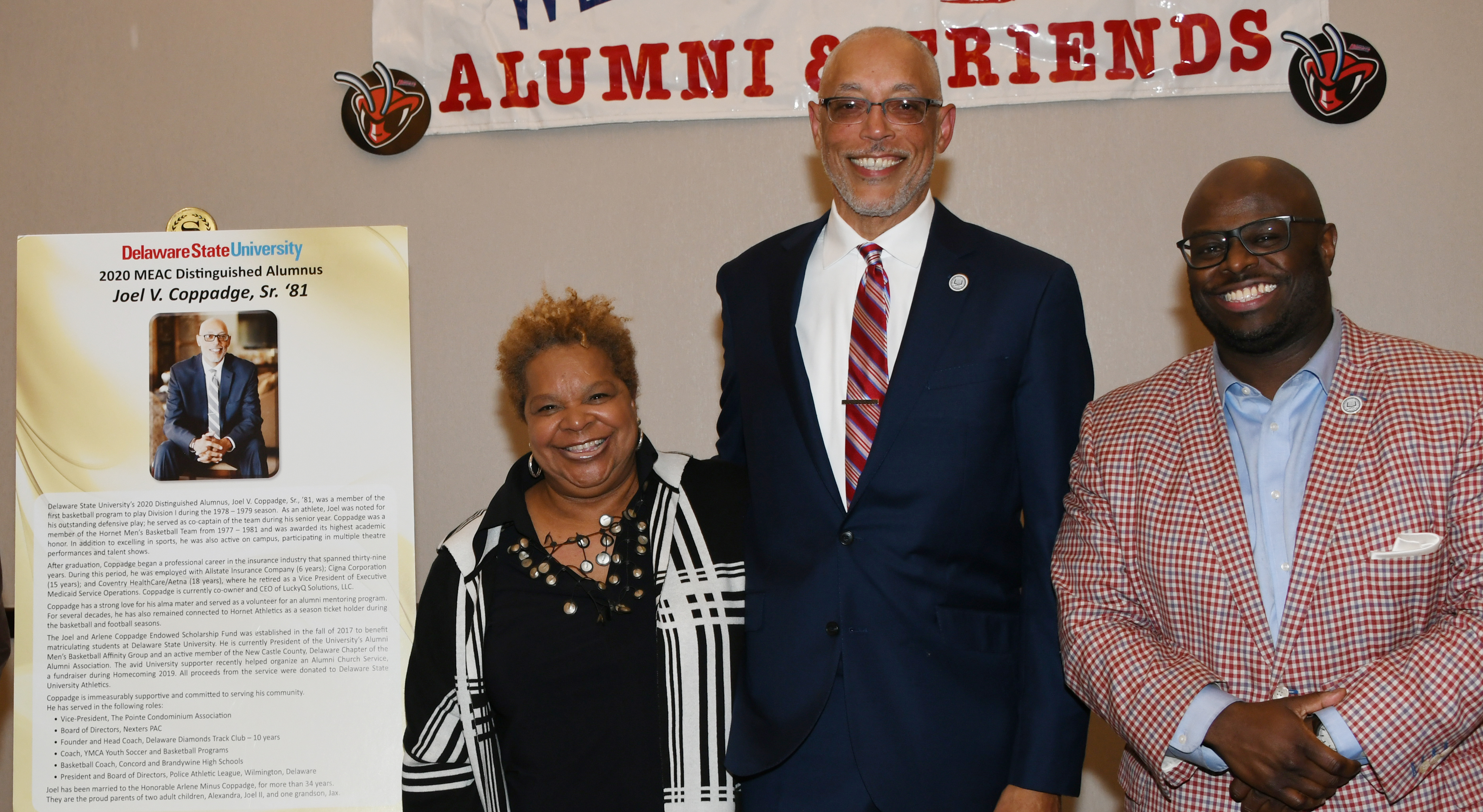 Distinguished Alumnus of 2020, Joel Coppadge (center), Class of 1981, stands with his wife Arlene and University President Tony Allen.   