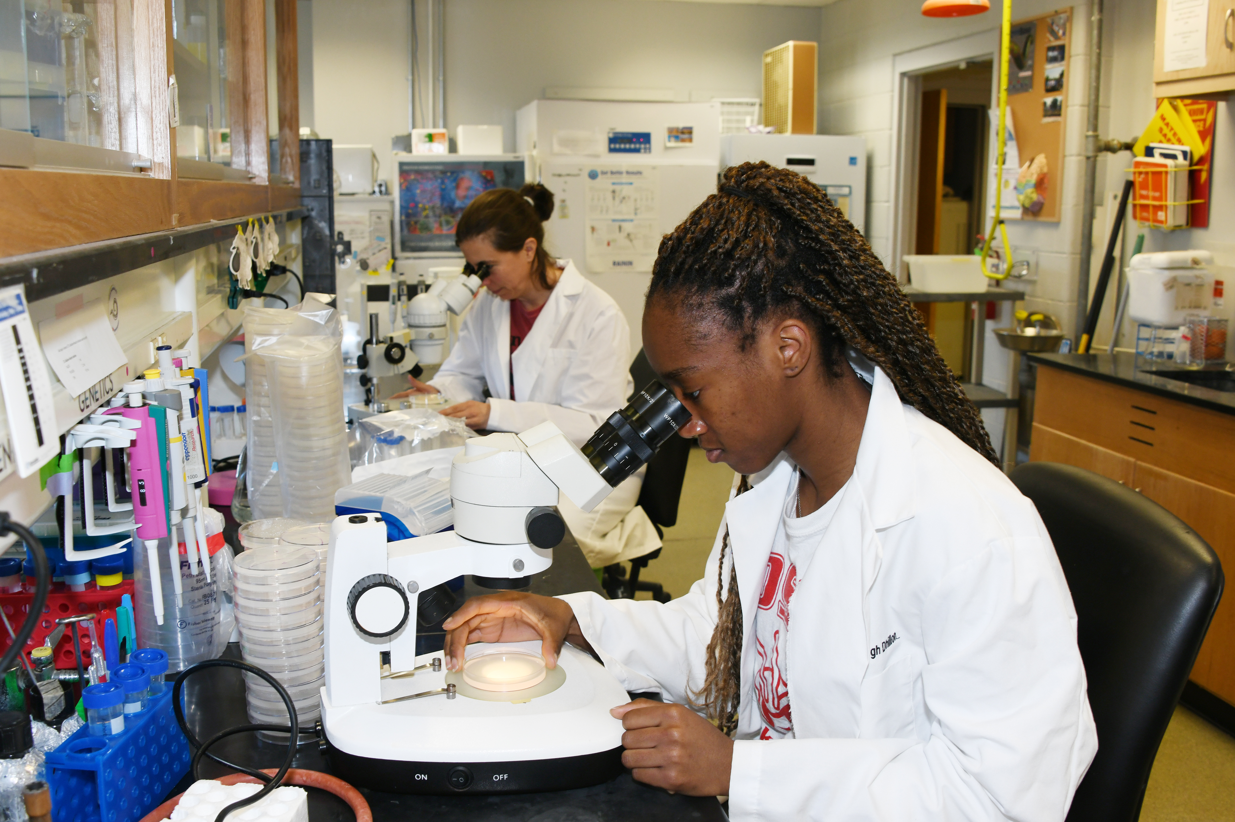 Researchers Sylvia Okafor and Megan Bone are continuing their work in the lab of Dr. Harbinder S. Dhillon, associate professor of biological sciences, despite the ongoing COVID-19 crisis.