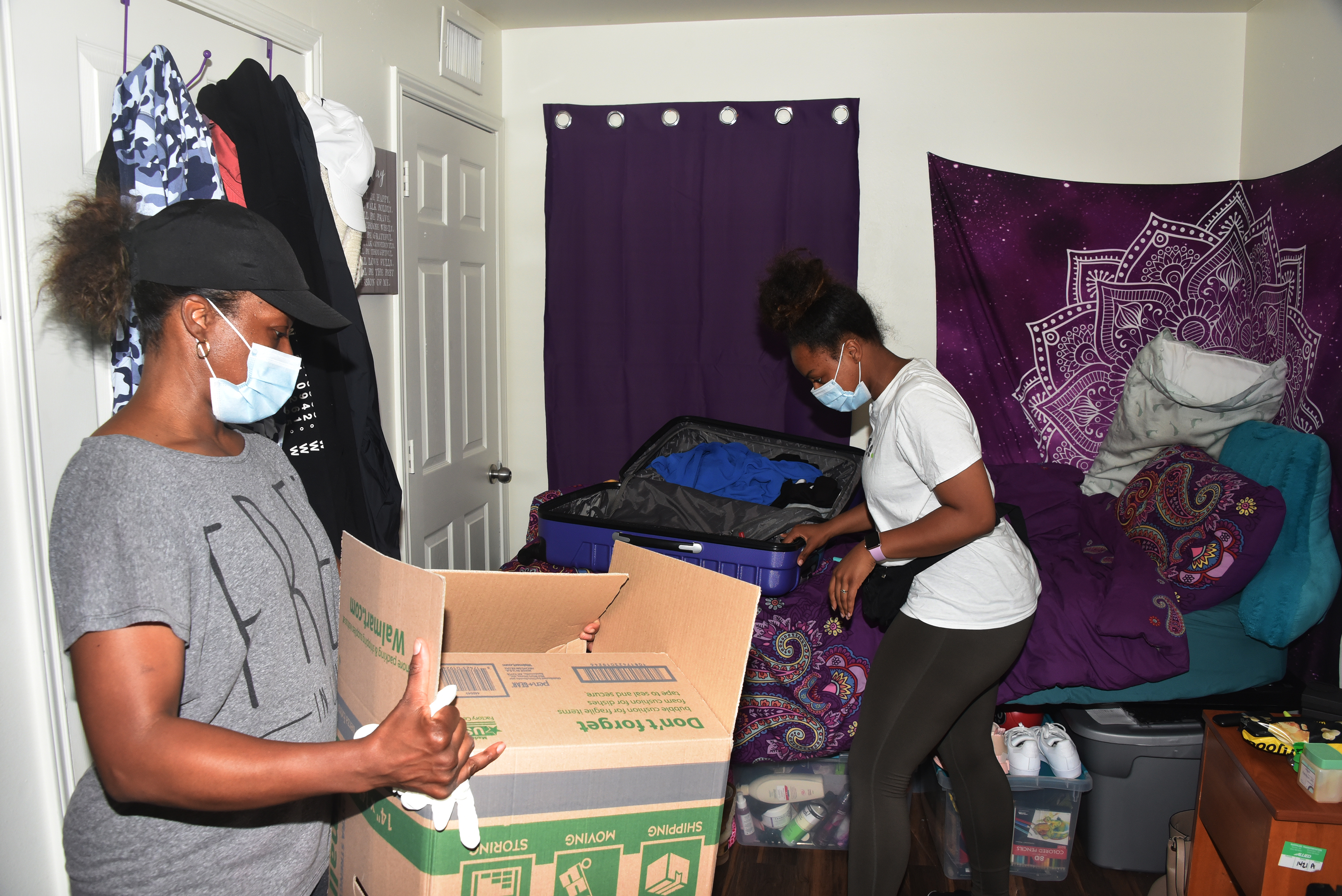 Lucinda Ward (l) helps her daughter, Caityn Ward, pack up her belongings. A 2020 graduate, Caityn is among the 270 recent graduates who are collecting their possessions and clearing out of their residences May 26-29.