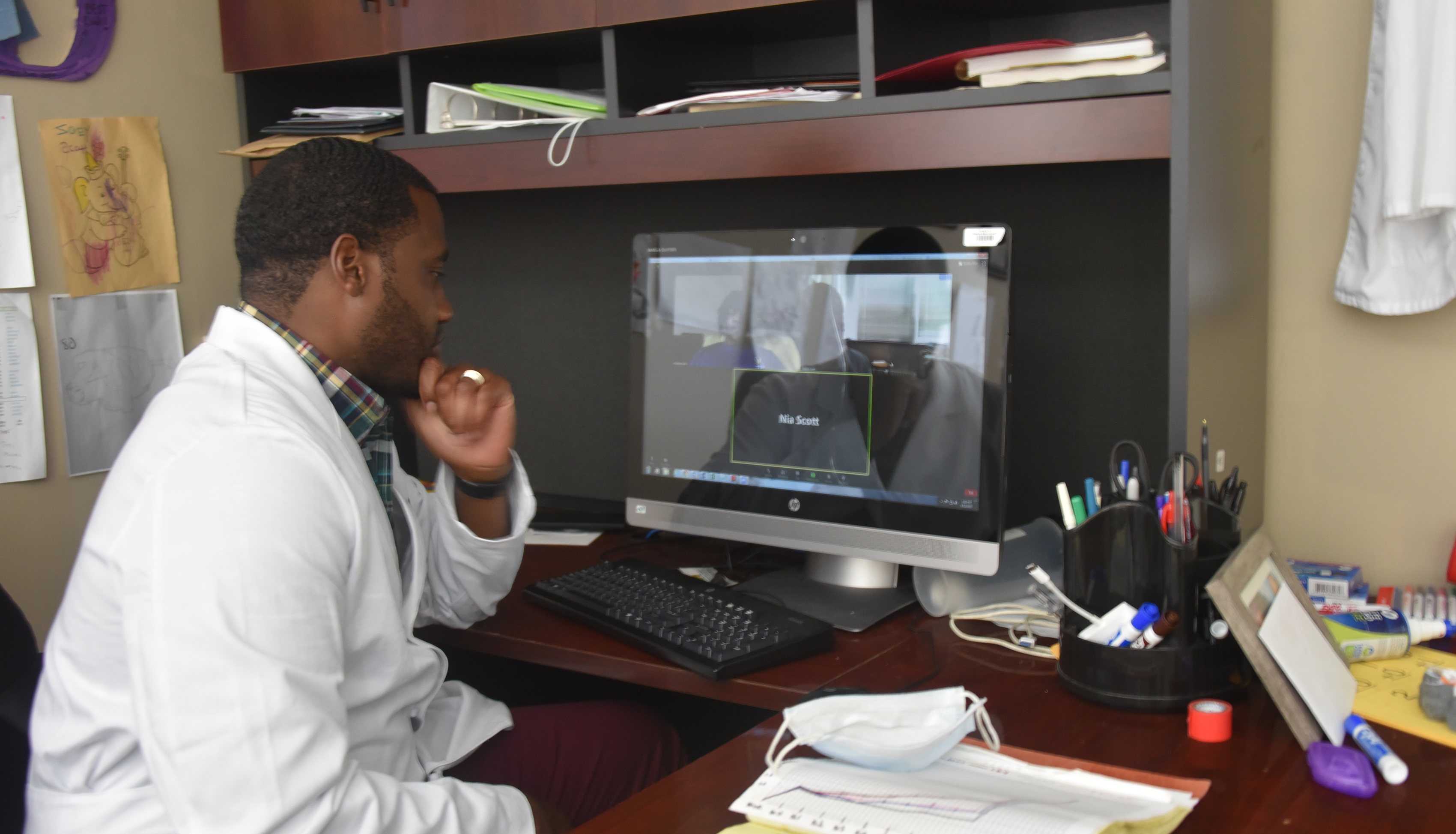 Dr. Derrick Scott, Assistant Professor of Biological Sciences, meets with two students who are working with him on a virtual research project involving the CHO cell line. The research -- which is being done in collaboration with three other Universities -- could help advance the development of a COVID-19 vaccine.