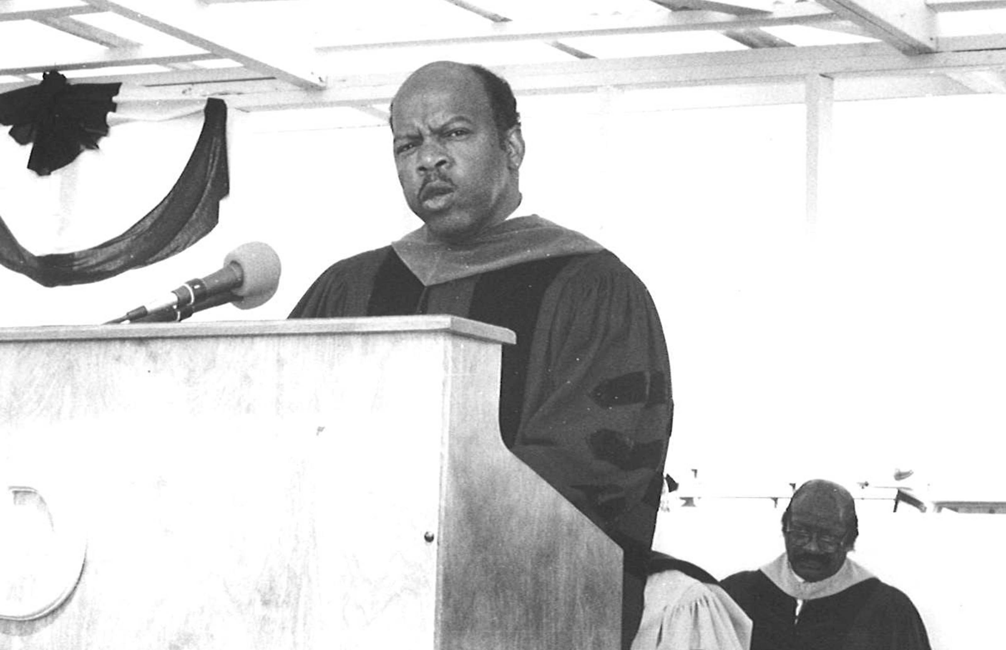 John Lewis gave the keynote address at then-Delaware State College's 1988 Commencement Ceremony. Seated in the background is the late Rev. Rudolph Coleman, a counselor at the College and the longtime pastor of Mt. Zion AME Church. 