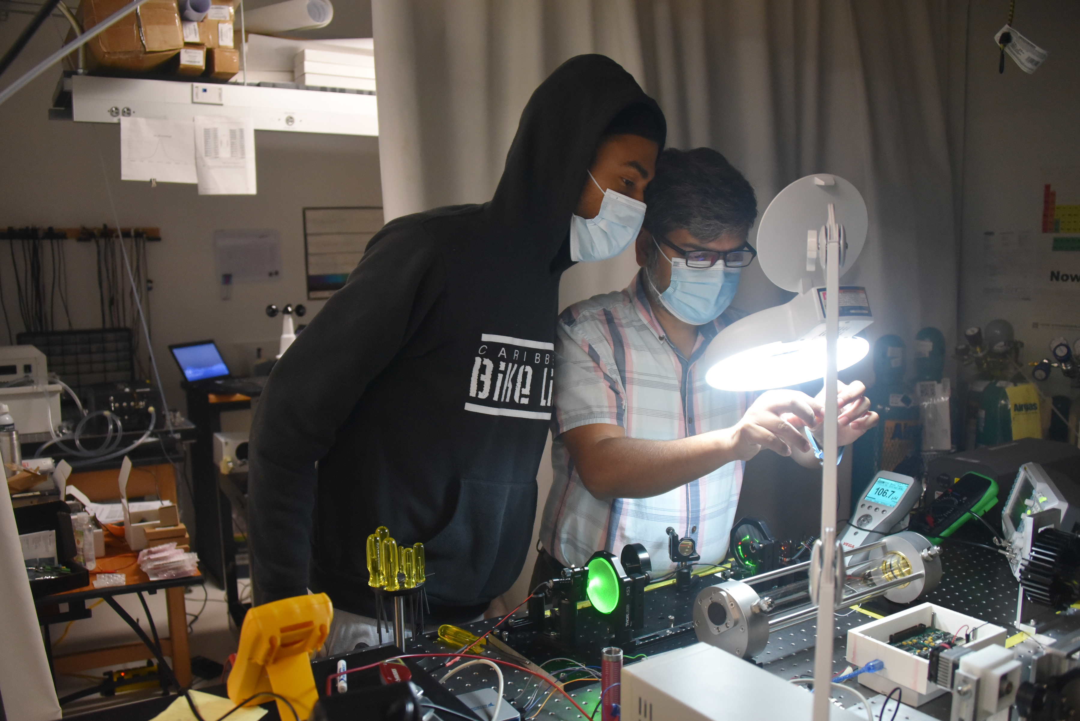 (L-r) Al R. Alexis, a graduate student in Optics, and Dr. Mohammed Khan, Associate Professor of Optics, work in the labs of the OSCAR Building, which will be the site of isotopic signature sensing research recently funded by the Department of Defense. 