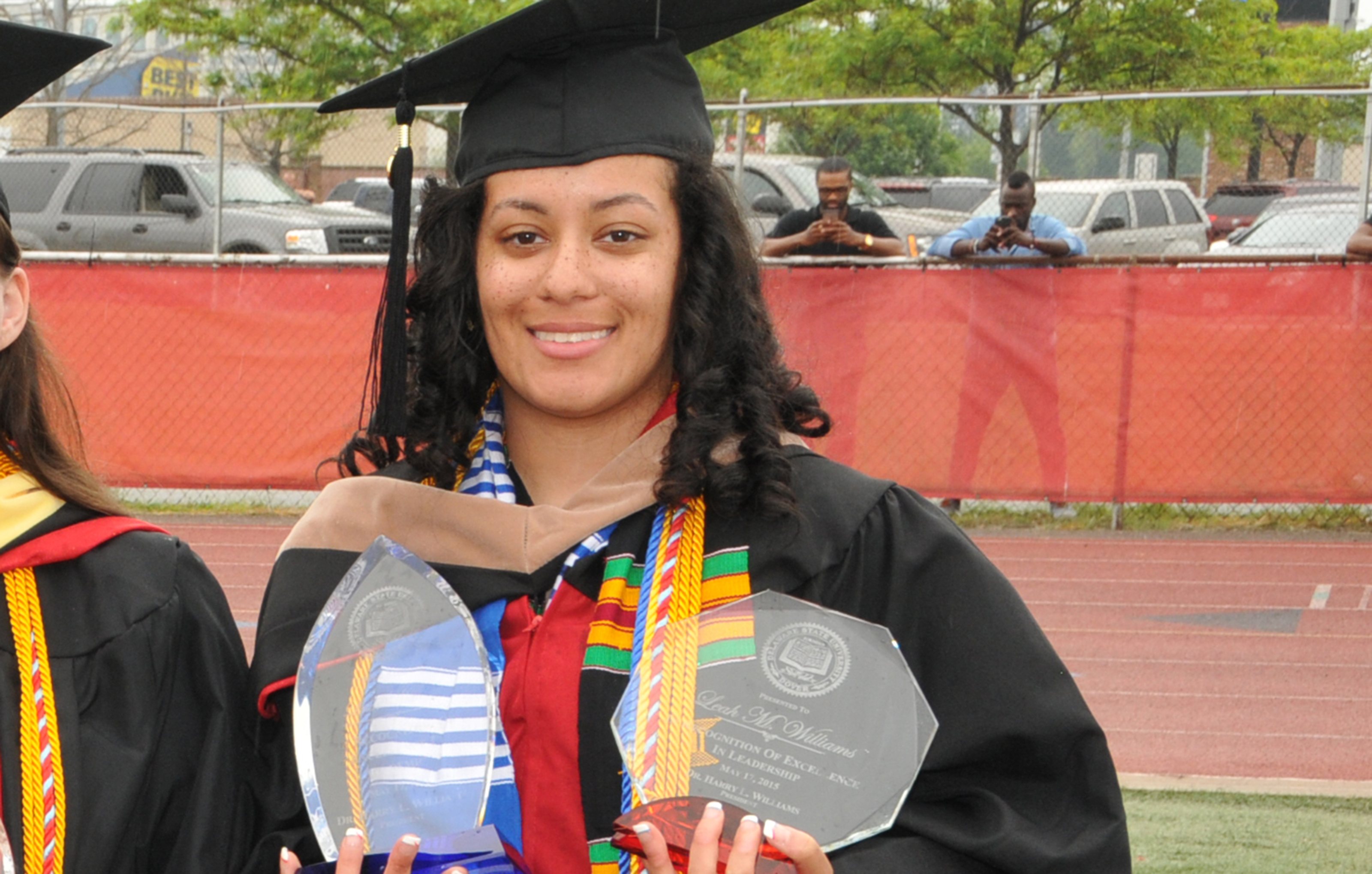 Leah Williams, 2020 Convocation keynote speaker, is shown in a 2015 graduation photo as she holds her University history-making Presidential Academic Award and Presidential Leadership Award -- the only Del State graduate to win both awards.