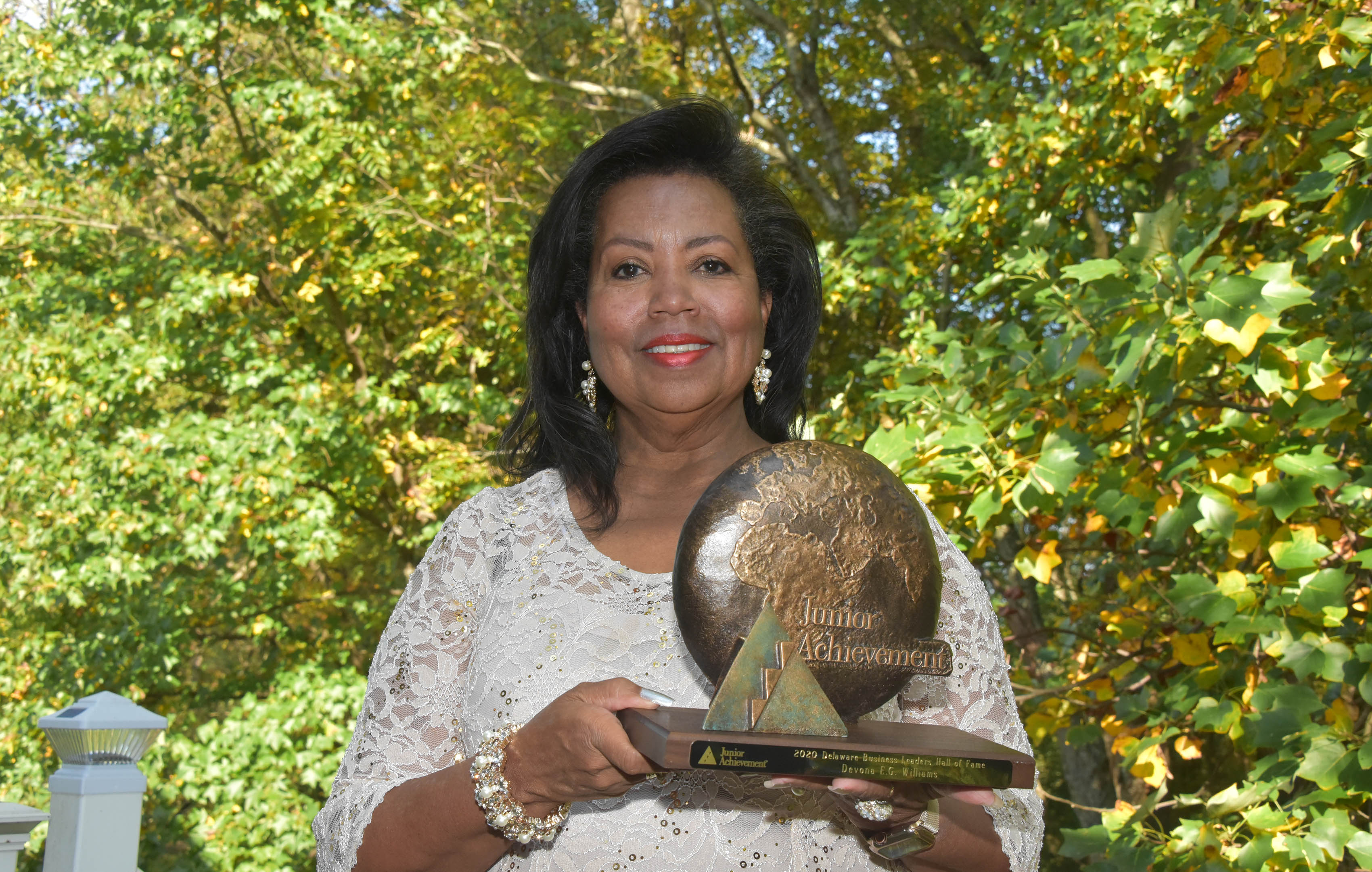 Dr. Devona Williams, University Board of Trustees Chairperson and founder and President/CEO of Goeins-Williams Associates, Inc., holds the award presented to upon her recent induction into the Delaware Business Hall of Fame.