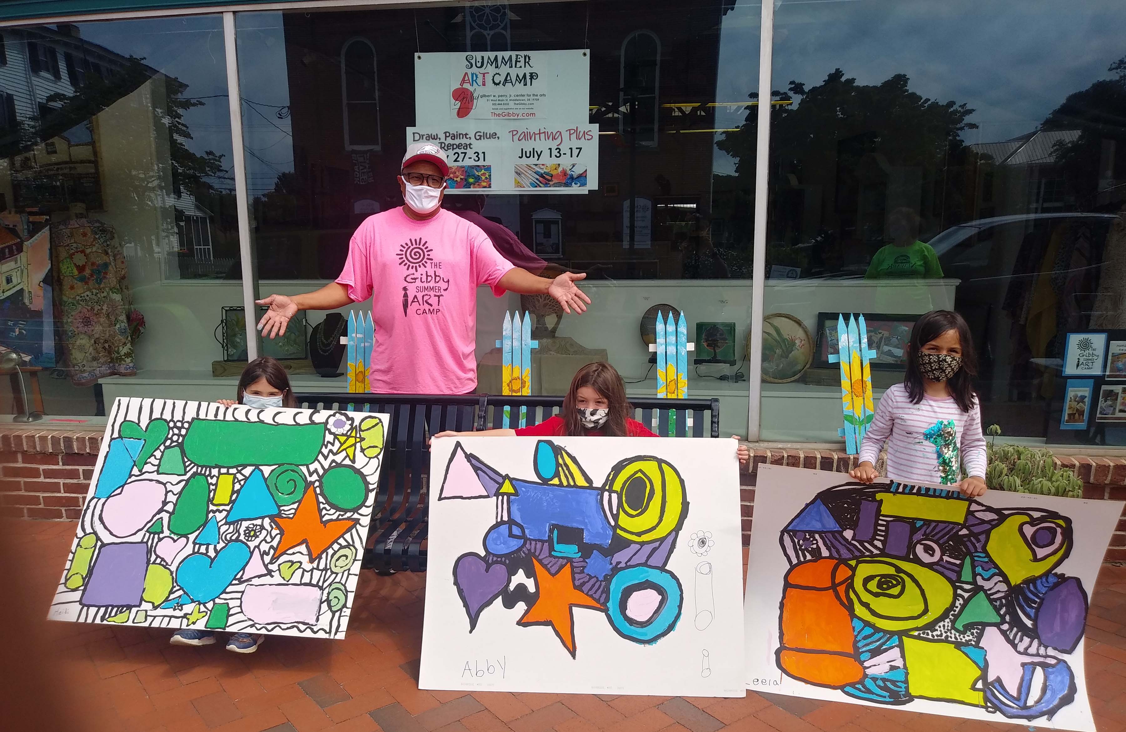 Milton Downing, 2021 Art Educator of the Year, stands with young summer camps participants and their painted creations at the Gibby Center for the Arts in Middletown.