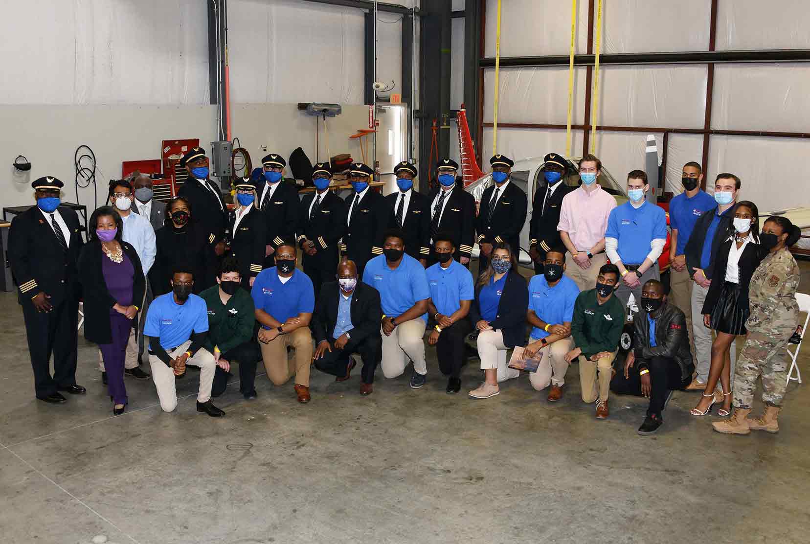 A group of Del State Aviation alumni (all United Airlines pilots), current Aviation students, and University officials come together for a group photo at the end of the April 15 celebration of Delaware State University partnership with United's Aviate Program.