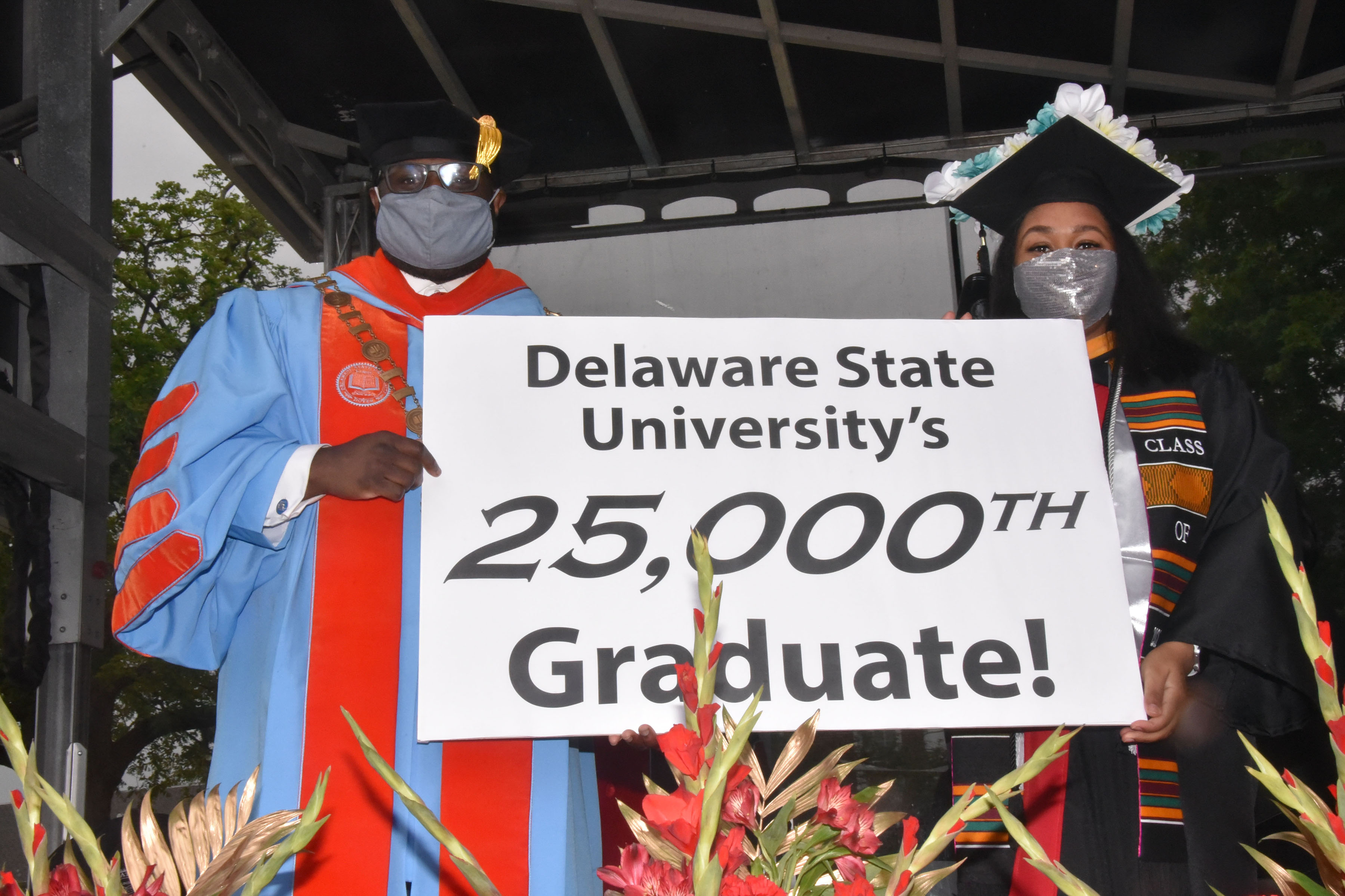 (L-r) University President Tony Allen stands with Celine Abigail Marie Coverdale, who not only celebrated the completion of her BS Degree in Chemistry/Pre-Professional, but also became the 25,000th graduate in the 130-year history of Delaware State University.