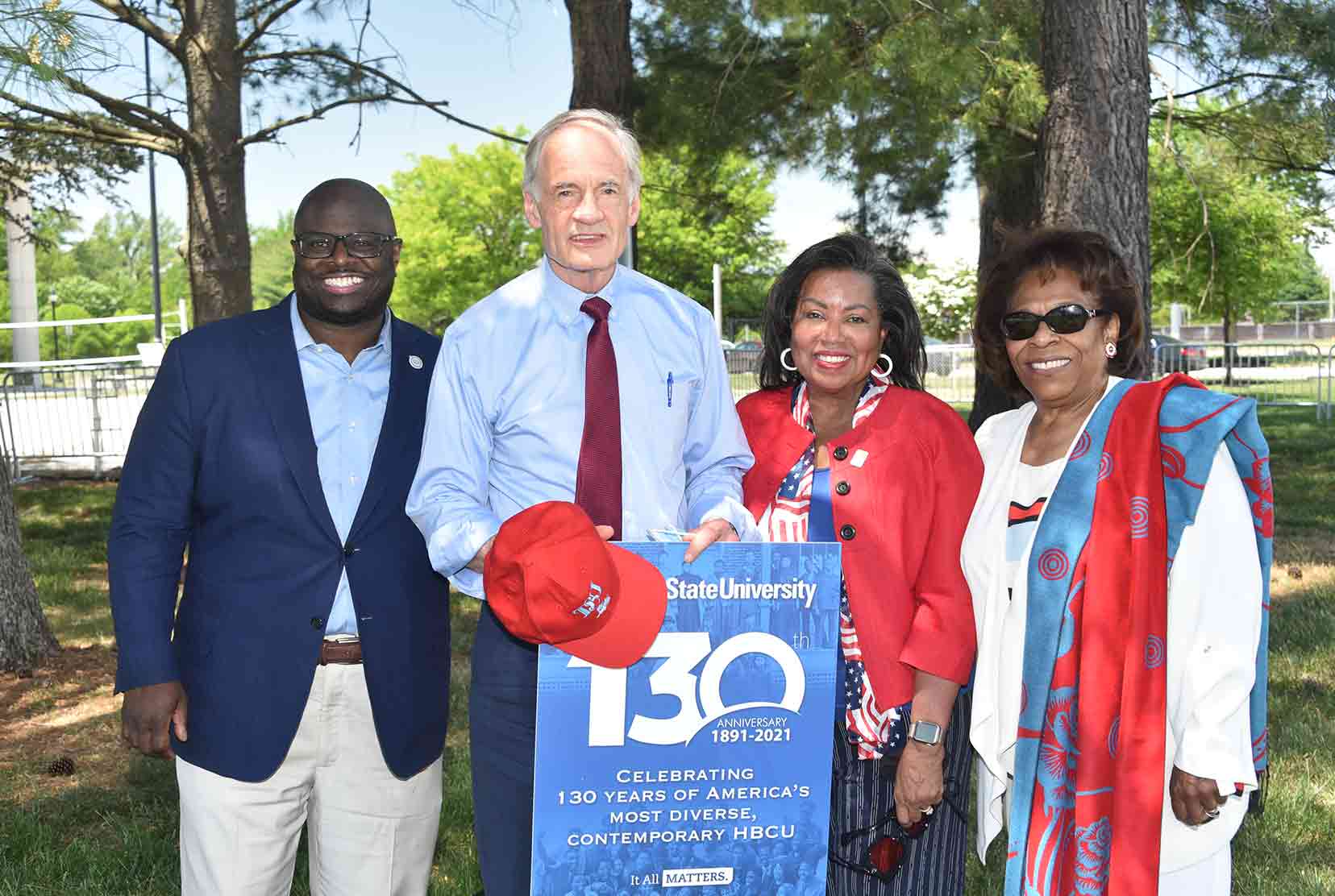 University President Tony Allen, U.S. Sen. Tom Carper, Del State Board Chairperson Devona Williams, and former University President Wilma Mishoe pose for a 130th Anniversary photo.