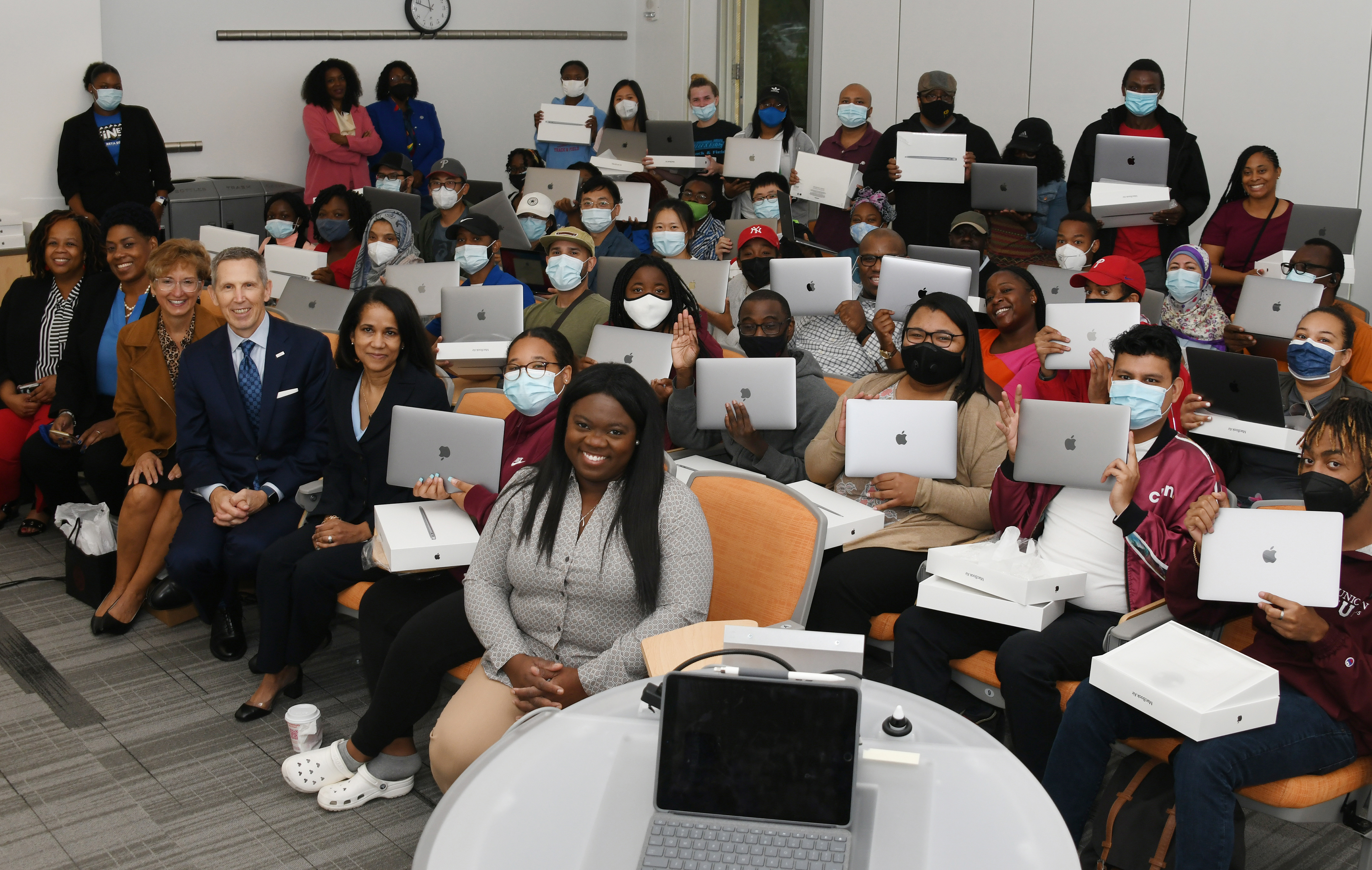 Pictured are some of the STEM graduate students who each received a MacBook from DuPont, which donated 50 of the high-end Apple laptop computers to Delaware State University. Seated in the front row are the DuPont officials that made the donation happen.