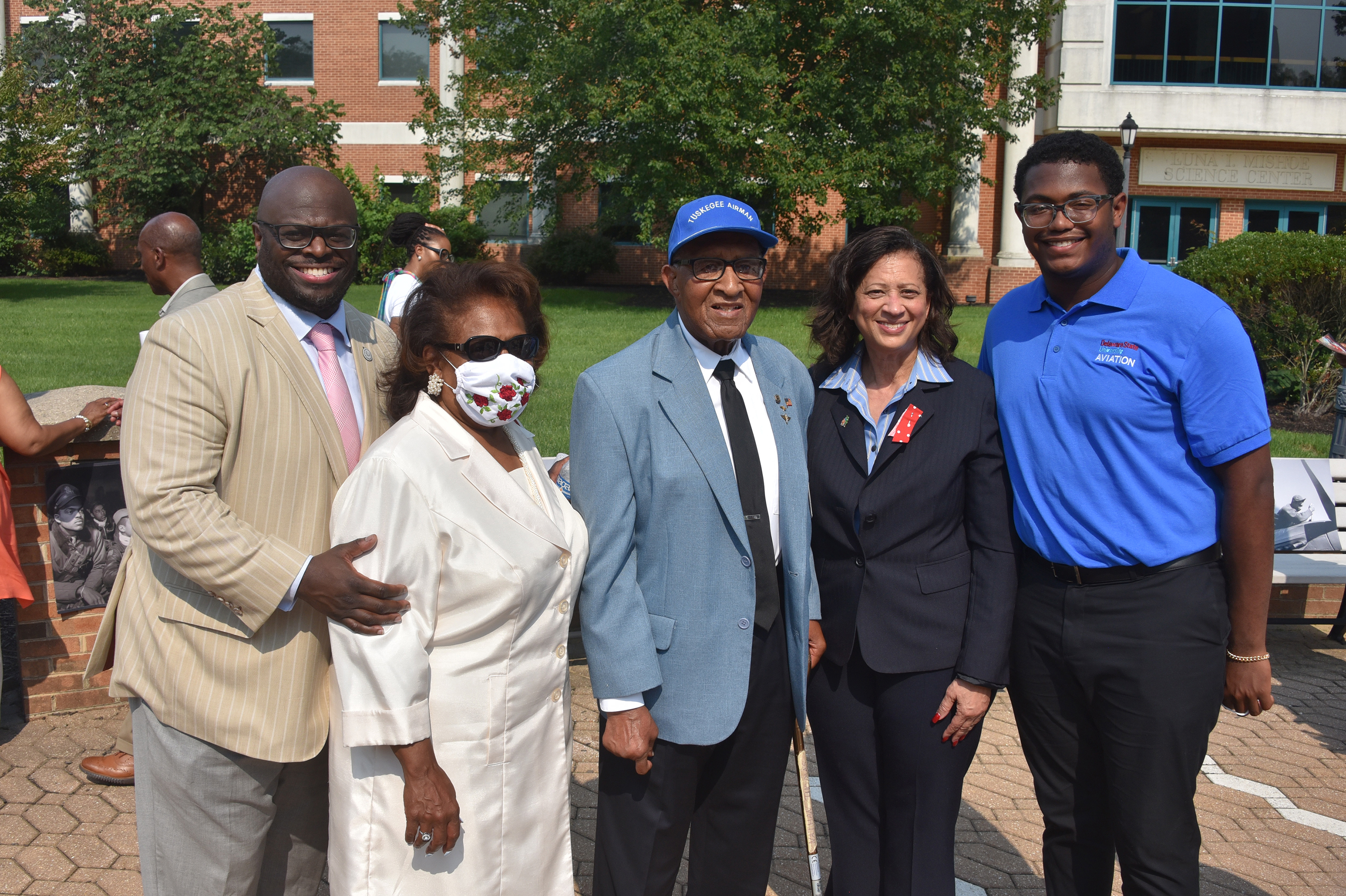 University President Tony Allen, Dr. Wilma Mishoe, Tuskegee Airman Nathan Thomas, Dr. Joi Spraggins of Legacy Bridges STEM Academy, and Aviation freshman Preston Stanberry pose for a group shot. Stanberry received a $1,000 scholarship from the Legacy Academy presented by Dr. Spraggins during the Tuskegee Airmen event.