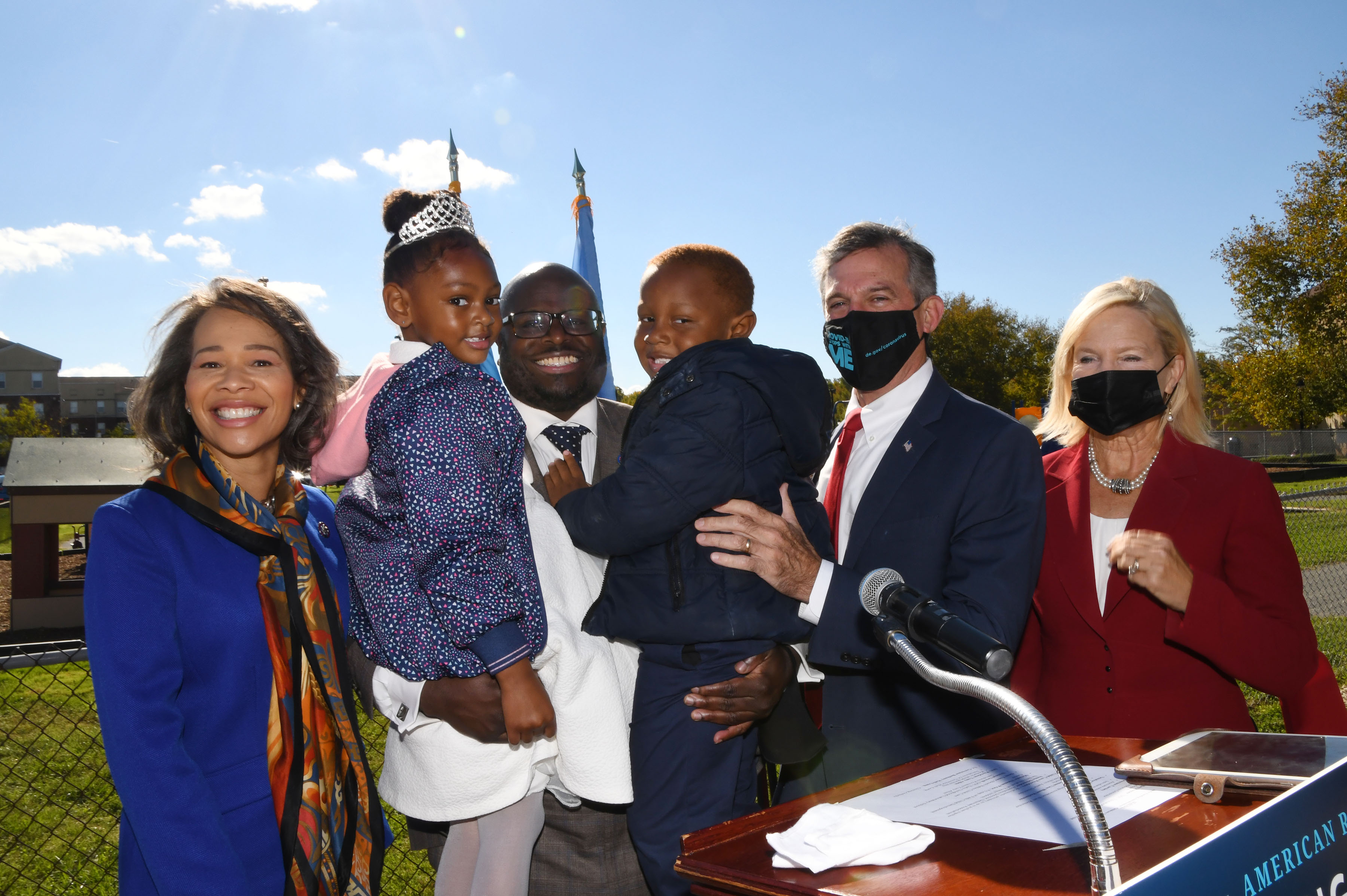 Flanked by Congresswoman Lisa Blunt Rochester, Gov. John Carney, Lt. Gov. Bethany Hall-Long, DSU President Tony Allen holds two beneficiaries of the Governor's initiative to strengthen early childhood education in Delaware -- the 2021-22 Little Mr. and Miss DSU, Corey Bazemore and Alessandra Spence. 