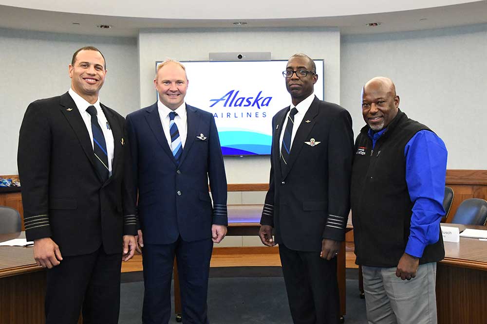 (L-r) Alaska Airlines group: Capt. J.P Wilson, Capt. Eric Braa, and Capt. Ron Limes, pose with Lt. Col. Michael Hales, Del State Aviation Program director. Alaska Airlines' True North Program will pay for selected student flight lab fees and provide a direct path to the pilots job with the airline.