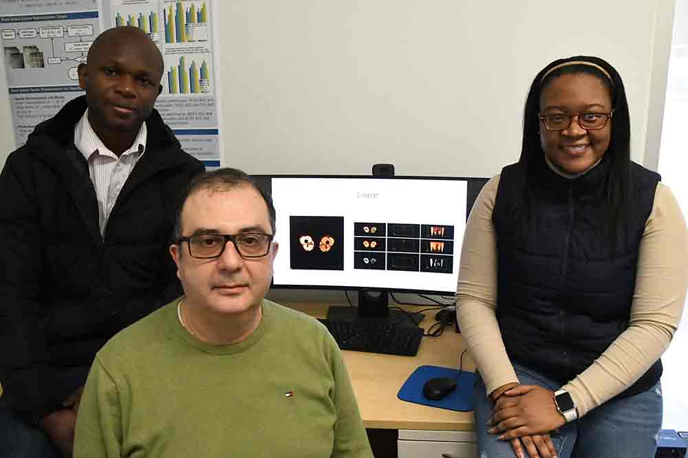 Dr. Sokratis Makrogiannis, Associate Professor (center), has been awarded a four-year $431,000 grant from the National Institute of Health for his research on imaging analysis and artificial learning methods as it relates to age-related diseases. With him are two assisting Ph.D. researchers -- Azubuike Okorie (l), of Amanato-Isu, Nigeria, and Chelsea Harris, of Felton, Del.