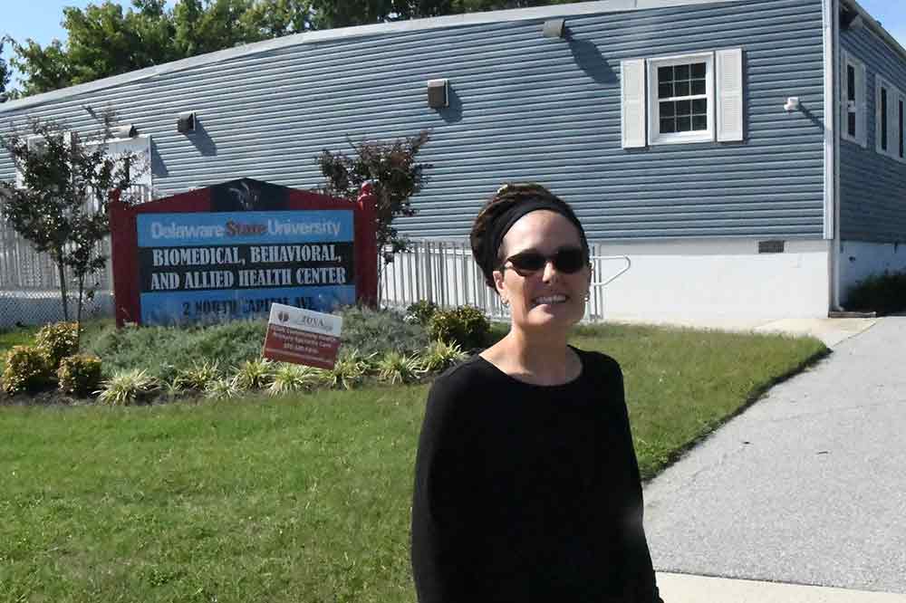 Dr. Cynthia Newton, Director of Partnerships & Programs, stands outside of the University's Biomedical, Behavioral and Allied Health Center located in the Capital Park neighborhood in Southeast Dover. This Center will figure greatly in the new Community Well-Being Initiative announced on Sept. 19.