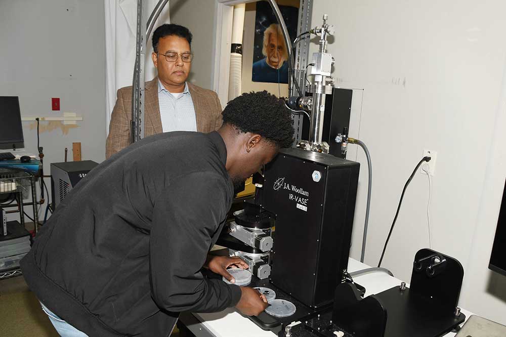 Marcellus London, a native of Dover and an MS in Applied Optics student, works with an ultra-thin material sample under the watchful eye of Dr. Mukti Rana, Professor of Physics and the Principal Investigator of the related $1 million research grant from the Department of Defense.
