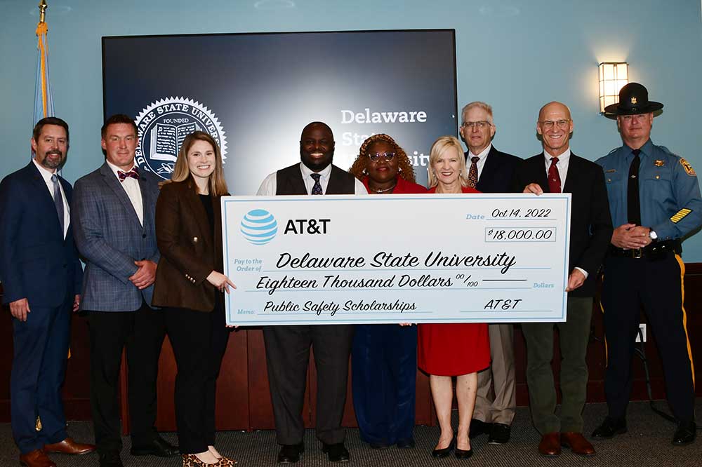 University President Tony Allen and Dr. Gwen Scott-Jones, Dean of the Wesley College of Health and Behavioral Sciences (both center), stand with a symbolic check held by AT&T Foundation's Katie McEvoy and Del. Lt. Gov. Bethany Hall-Long, which denotes an $18,000 donation presented in scholarship support for a trauma training certificate program. 