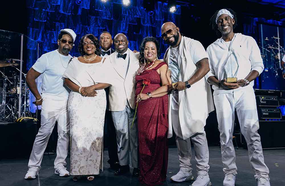 Boyz II Men group members pose with the University's Dr. Vita Pickrum, Vice President of Institutional Advancement, John Ridgeway, Board of Trustees Vice Chair, University President Tony Allen, and Board of Trustees Chair Dr. Devona Williams.